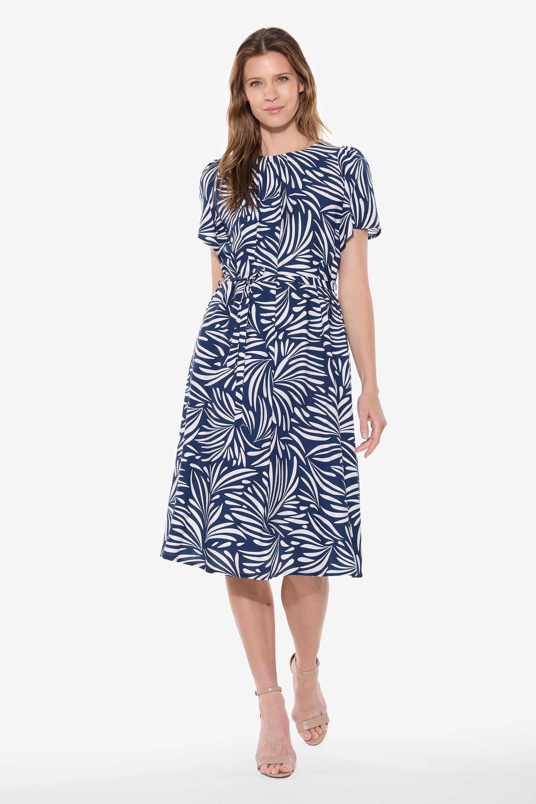 Woman wearing a blue and white patterned dress on a white background