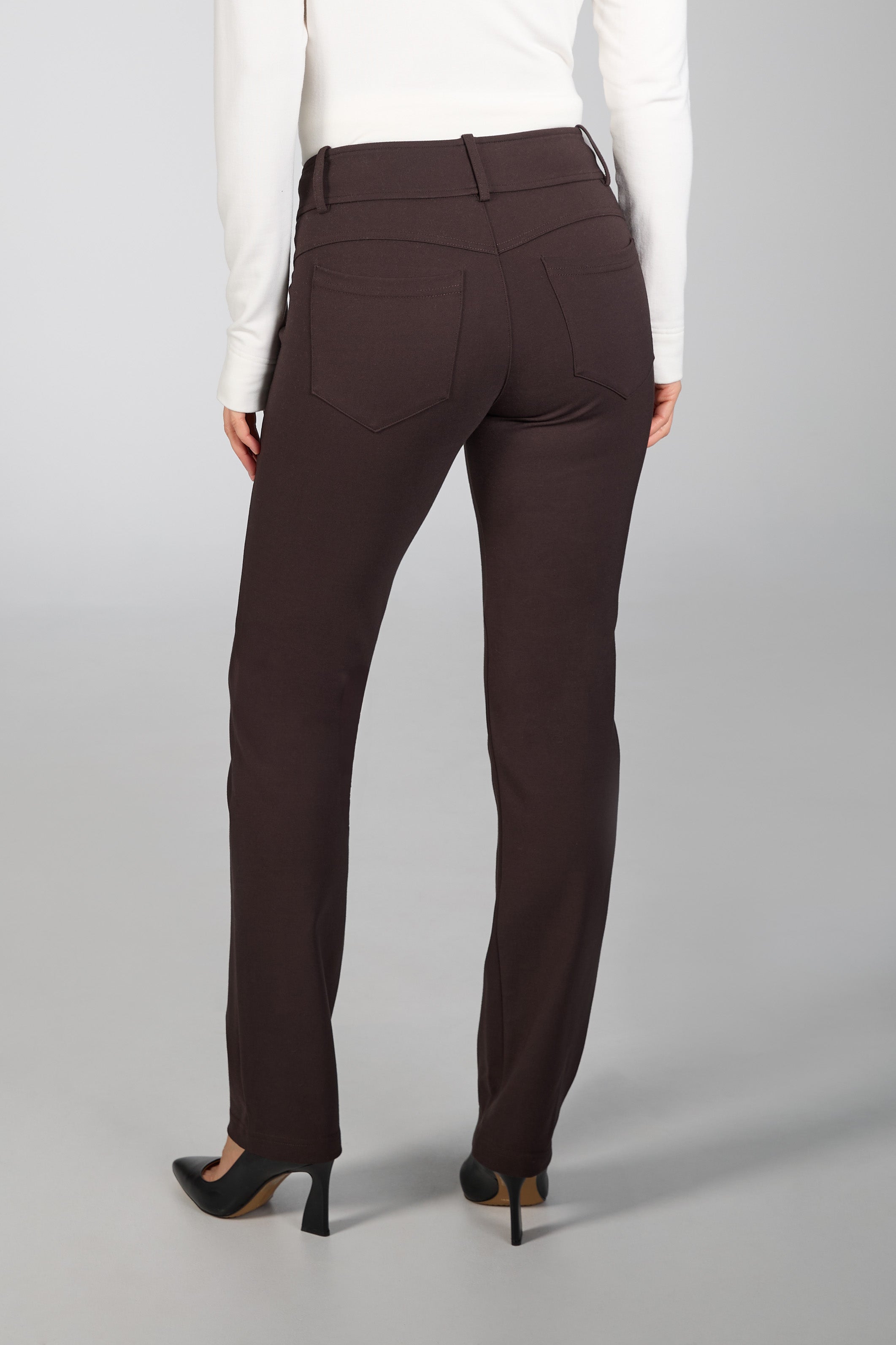 Brown pants worn by a person on a gray background