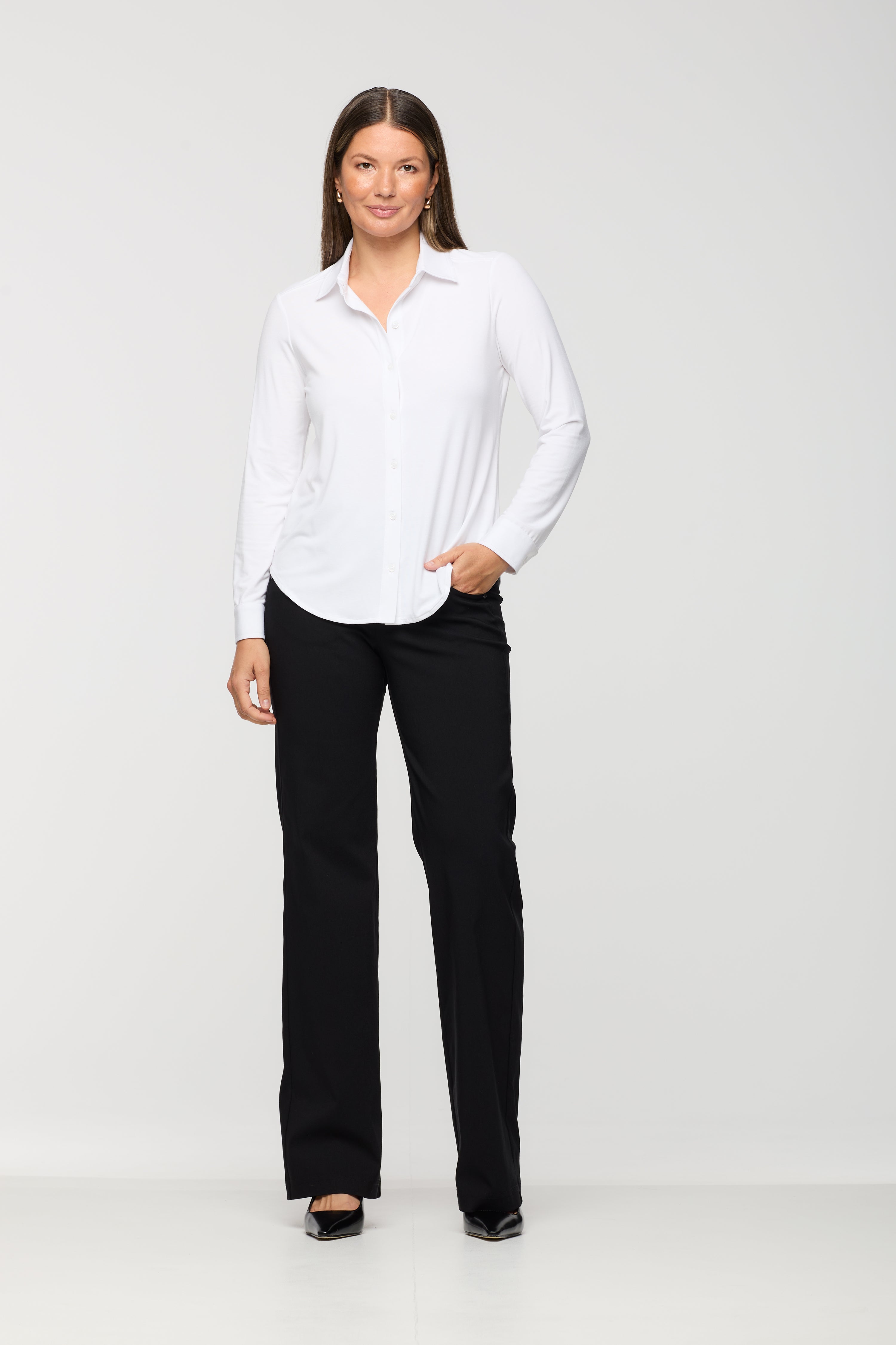 Woman wearing a white shirt and black pants on a white background