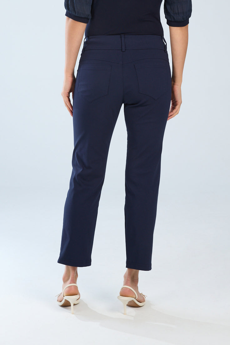 Person wearing navy blue pants on a white background back view