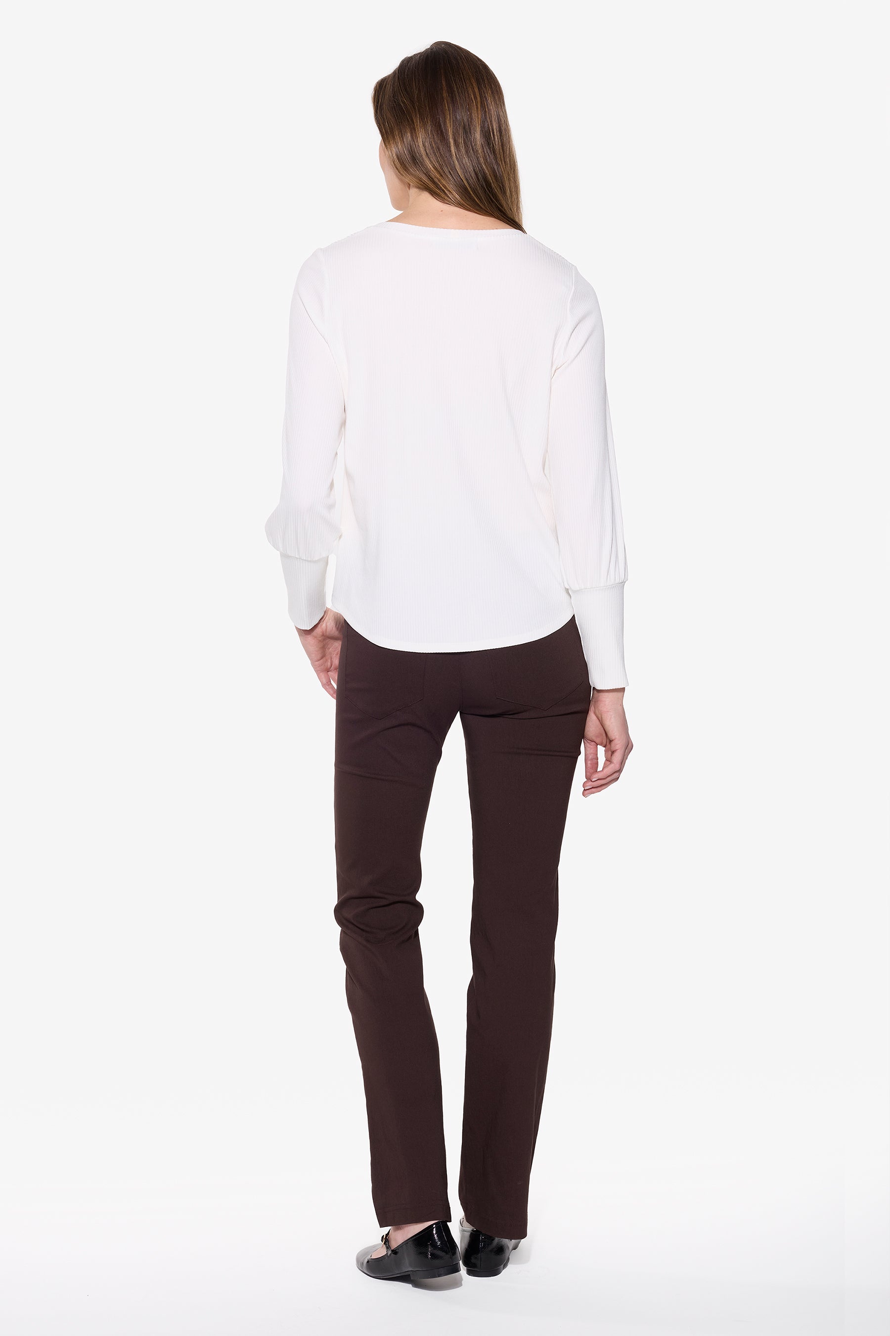 Person wearing a white shirt and brown pants on a white background
