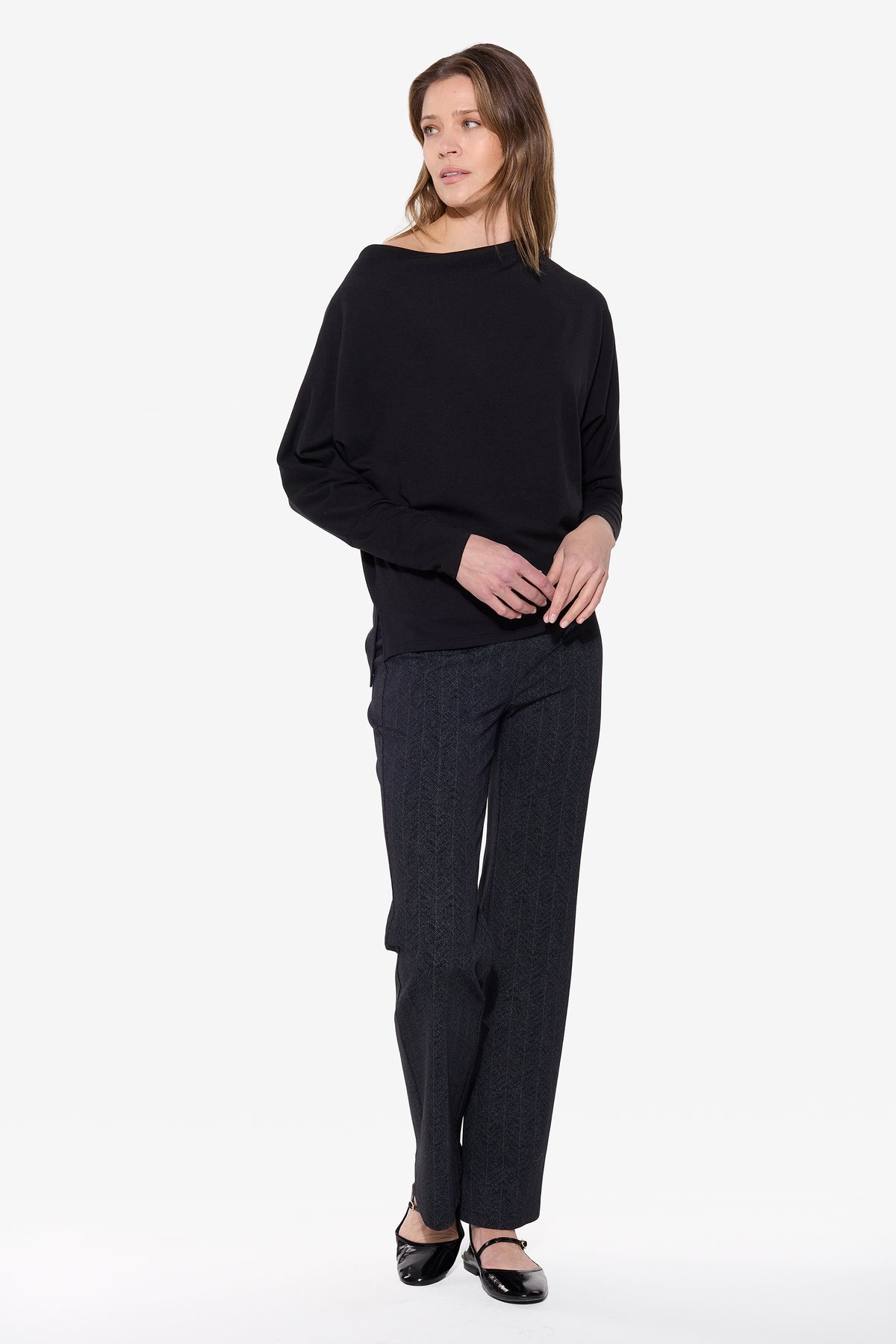 Woman wearing a black outfit on a white background