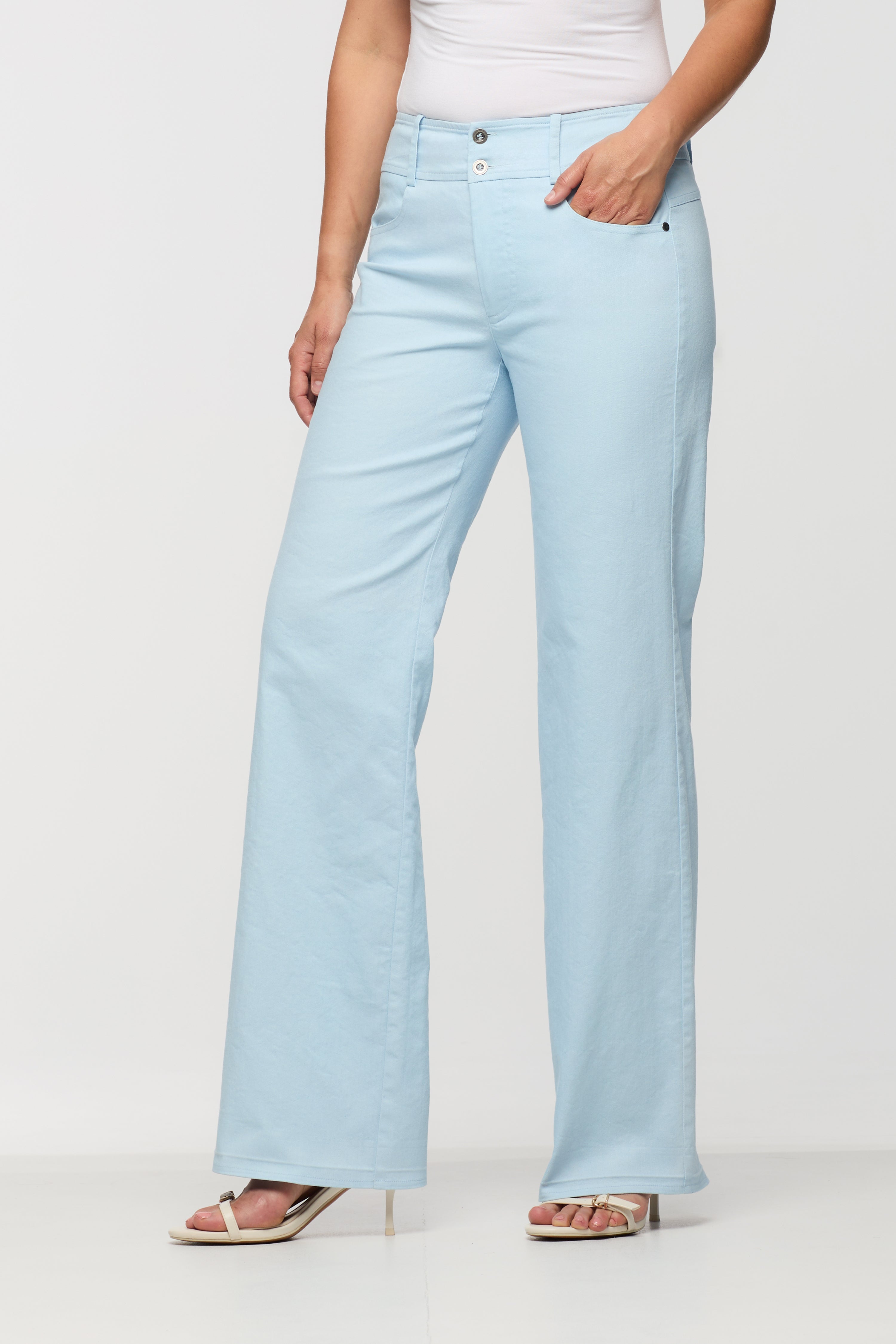 Light blue jeans worn by a person on a white background