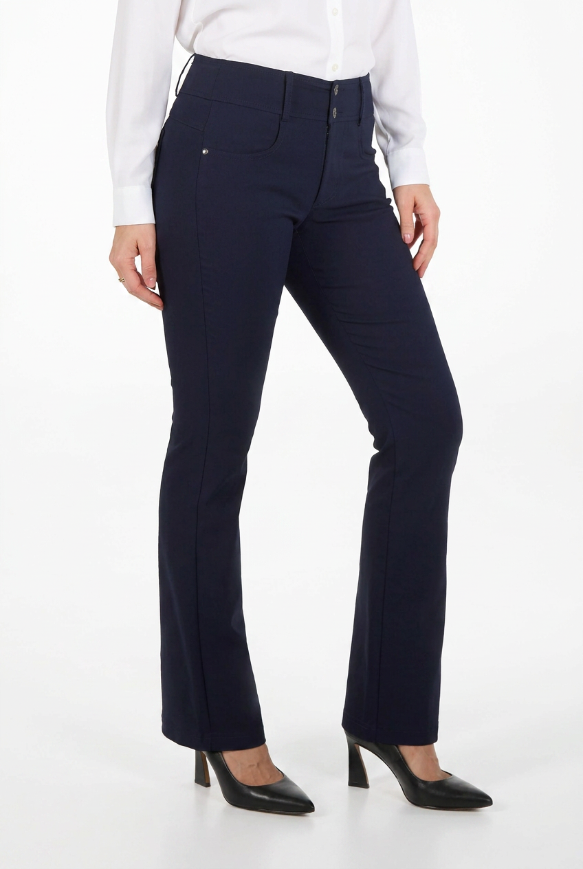A model wearing a pair of dark navy blue high-waisted flared trousers, styled with a white long-sleeve blouse and black pointed-toe heels, against a plain white studio background.