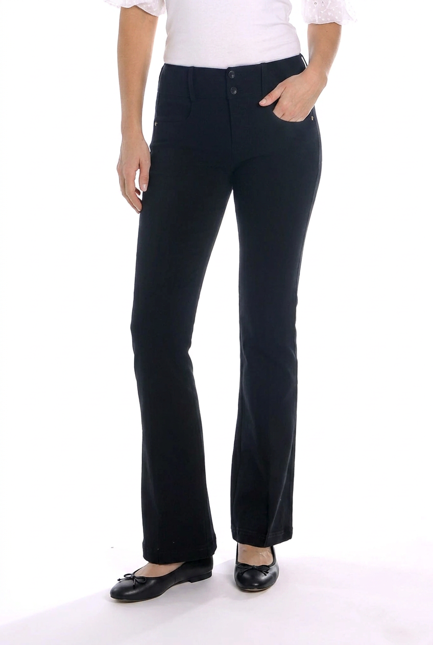 A model wearing black flared pants, paired with a white top and black flats, shown from the waist down against a white studio background.