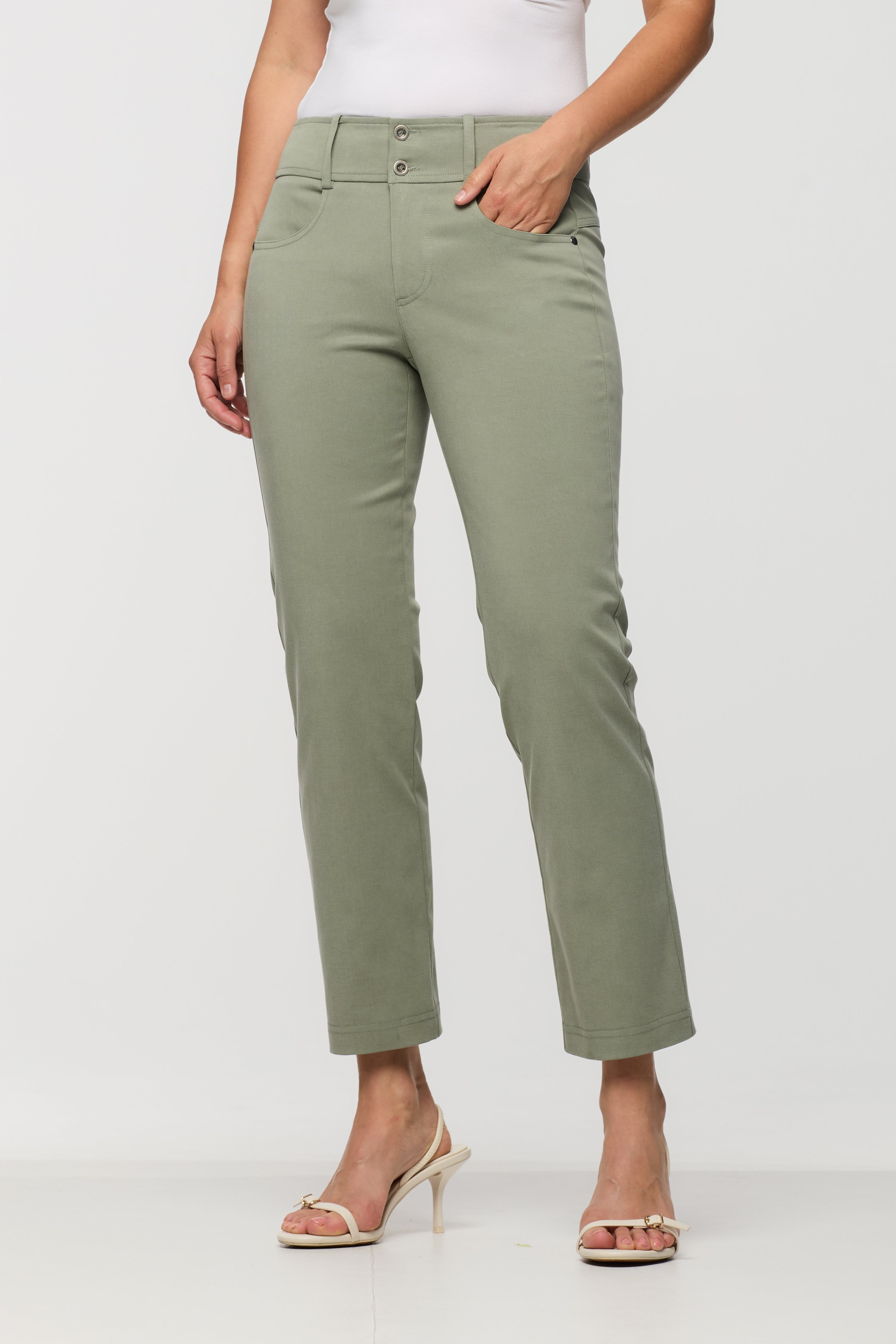 Woman wearing sage green cropped straight leg pants with a two-button waistband, front pockets, and a streamlined fit.