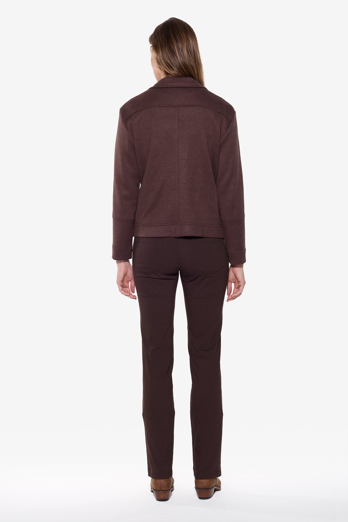 Person wearing a brown jacket and pants on a white background