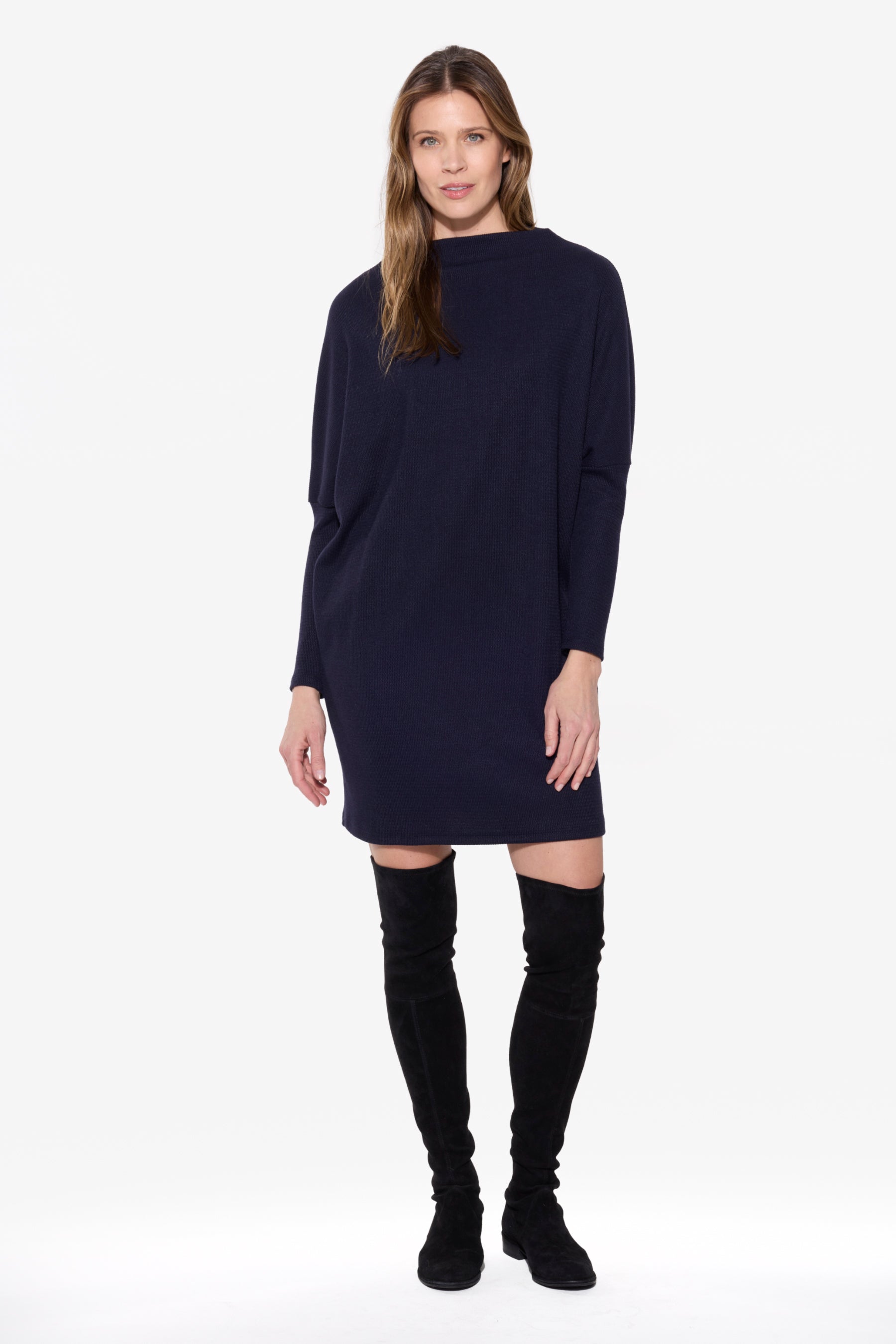 Model wearing the BEDDOME Dolman Mock Neck Dress in Navy, a relaxed knit dress with a soft mock neckline and dolman sleeves.