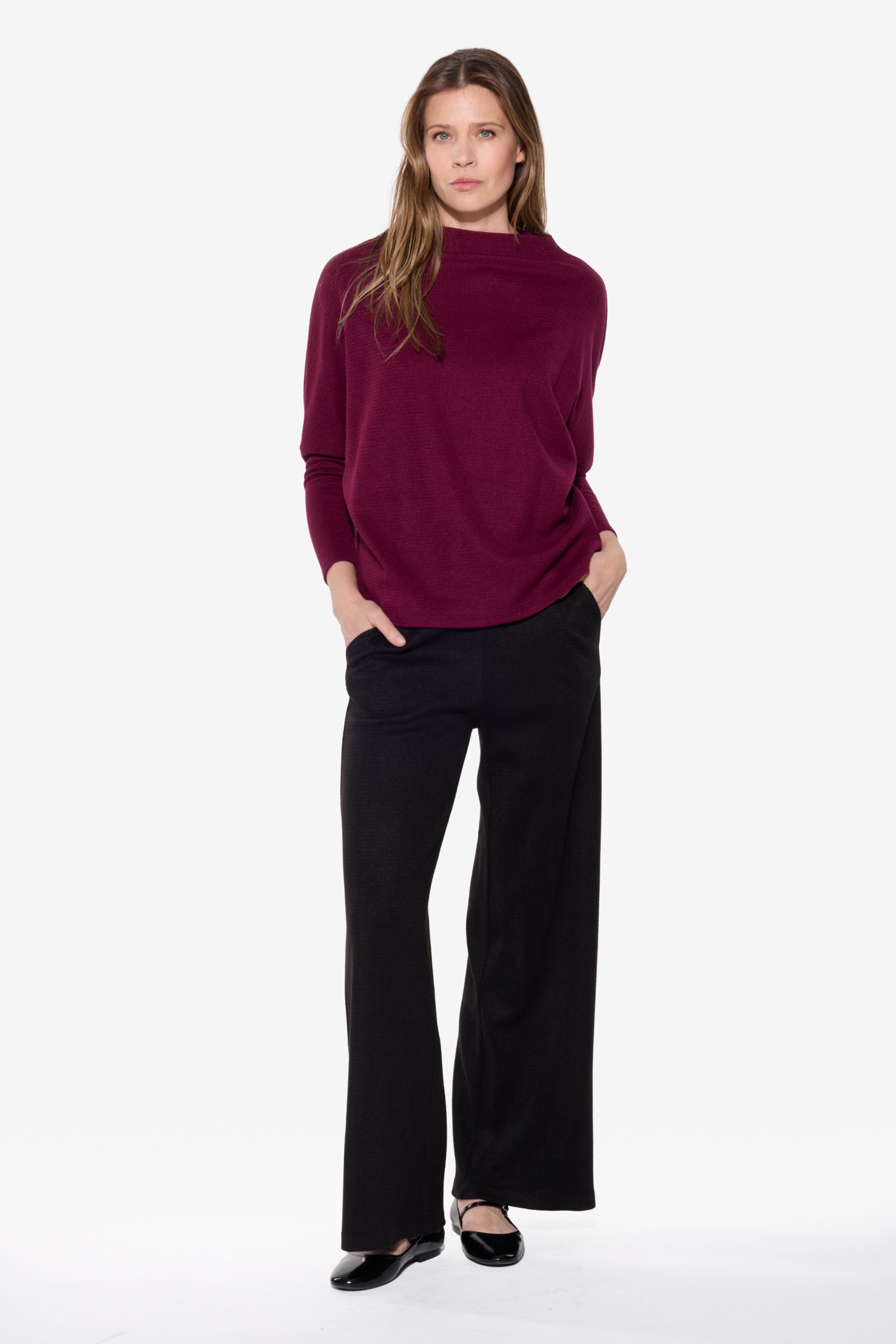 Model wearing the BEDDOME Mock Neck Dolman Sweater in Burgundy, featuring a soft mock neckline, relaxed dolman sleeves, and a relaxed fit.