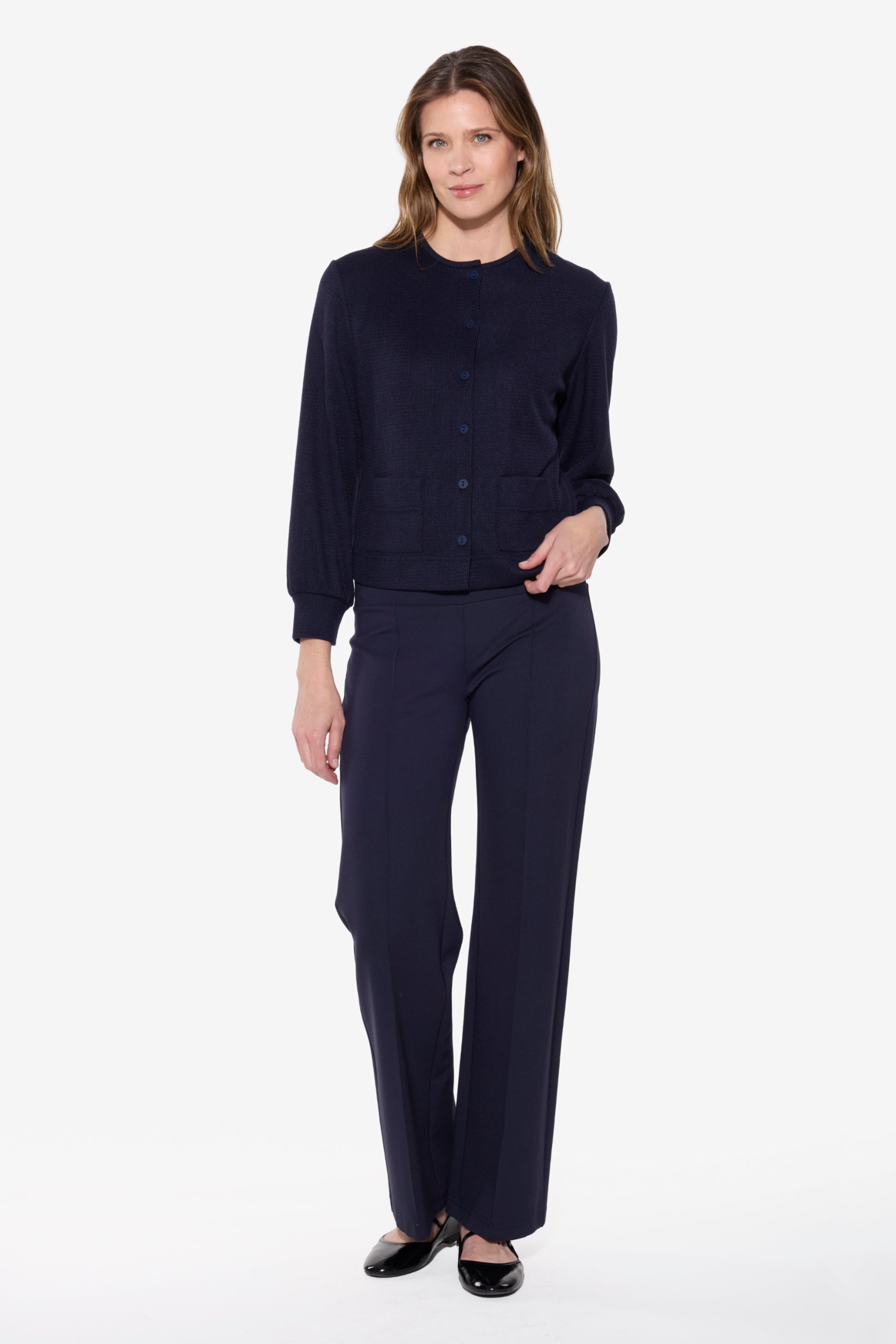 Woman wearing a navy blue outfit on a white background