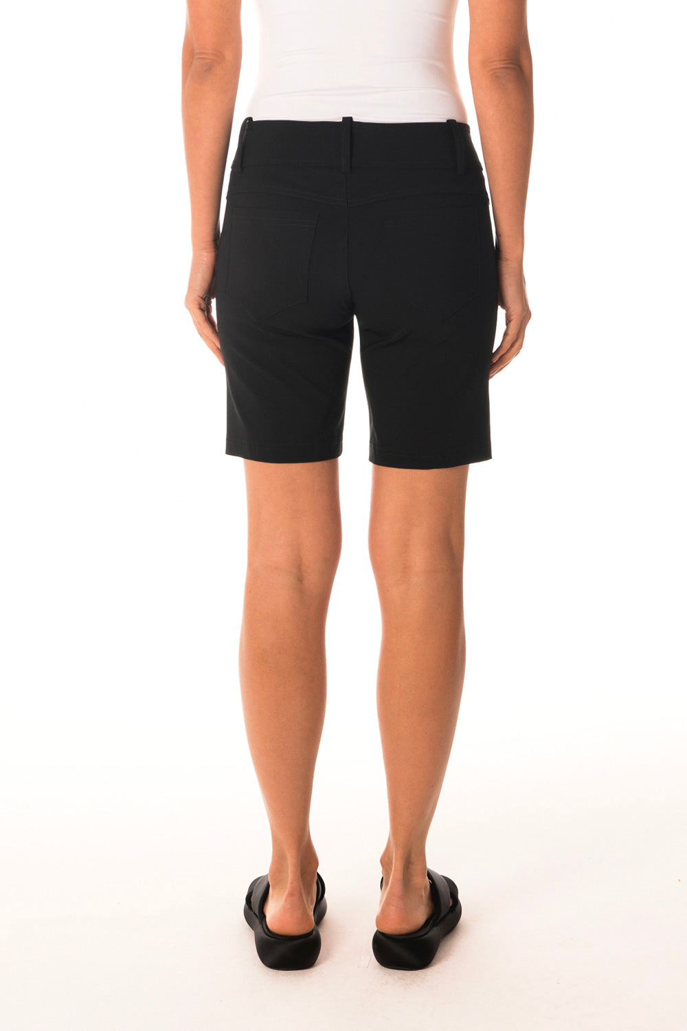 Person wearing black shorts on a white background back view