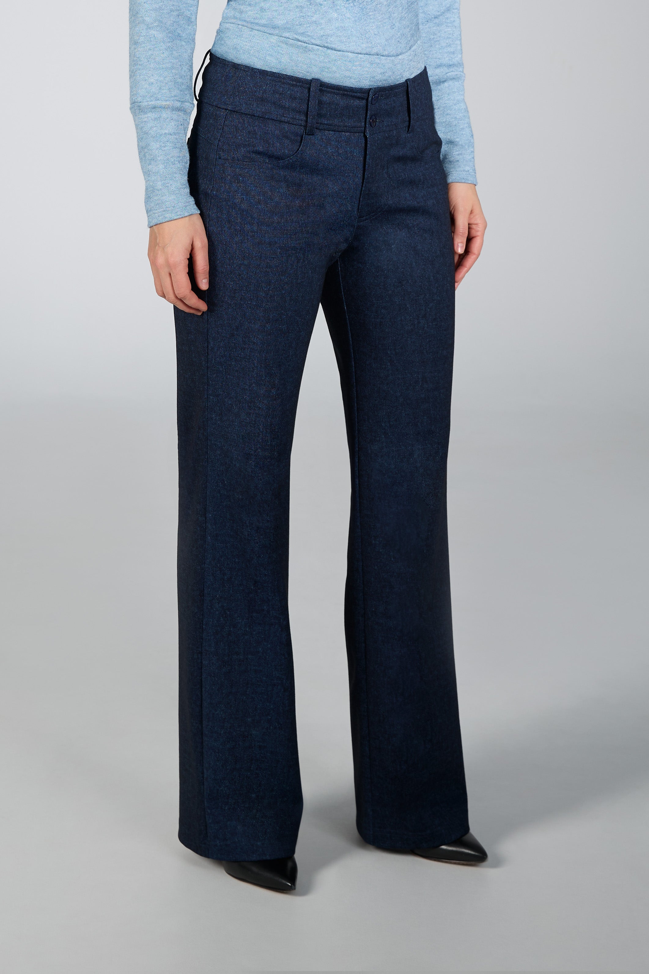 Navy blue pants worn by a person on a gray background