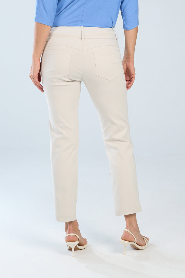 Person wearing beige pants and a blue top on a white background