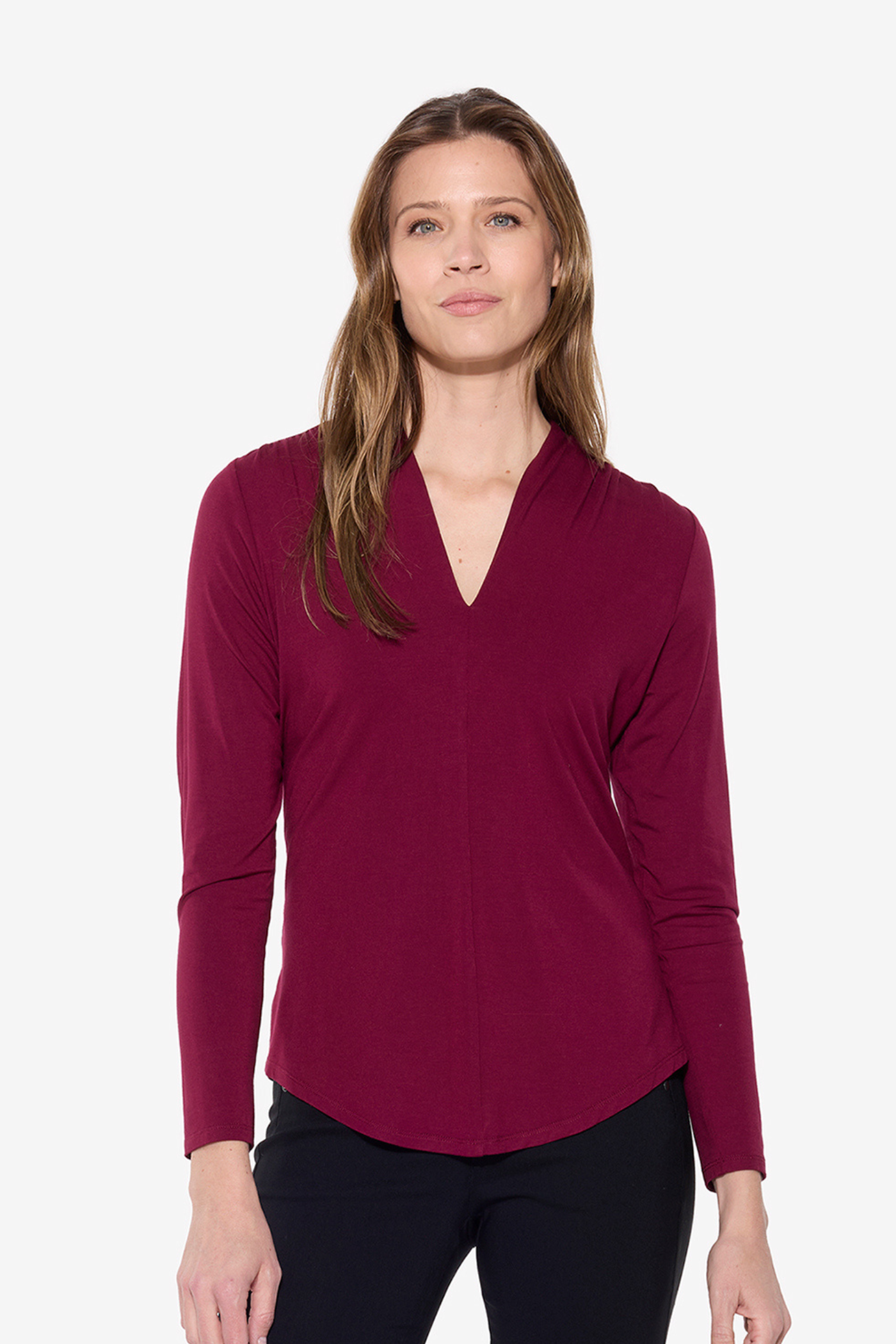 Woman wearing a burgundy long-sleeve top on a white background