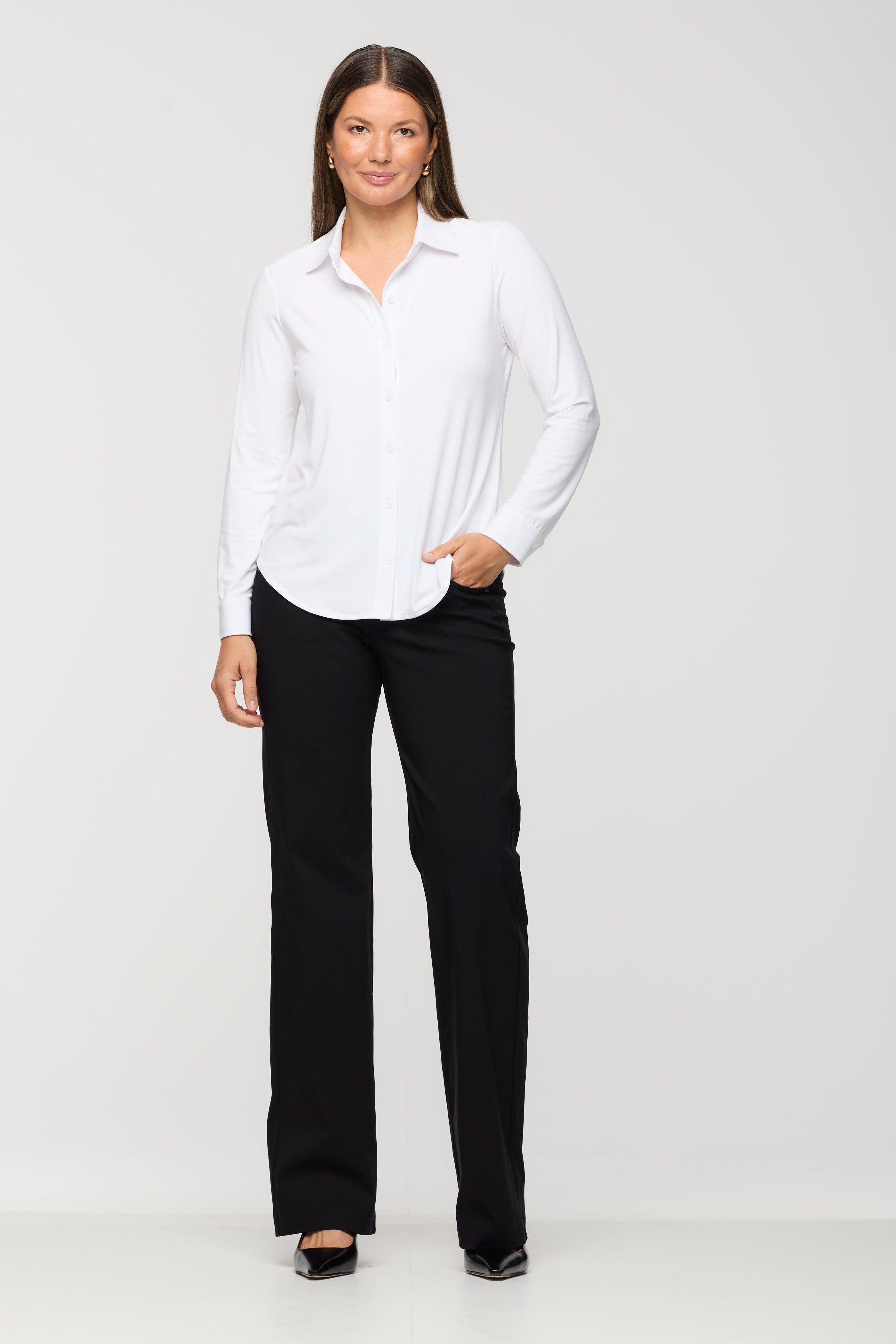 Woman wearing a white shirt and black pants on a white background