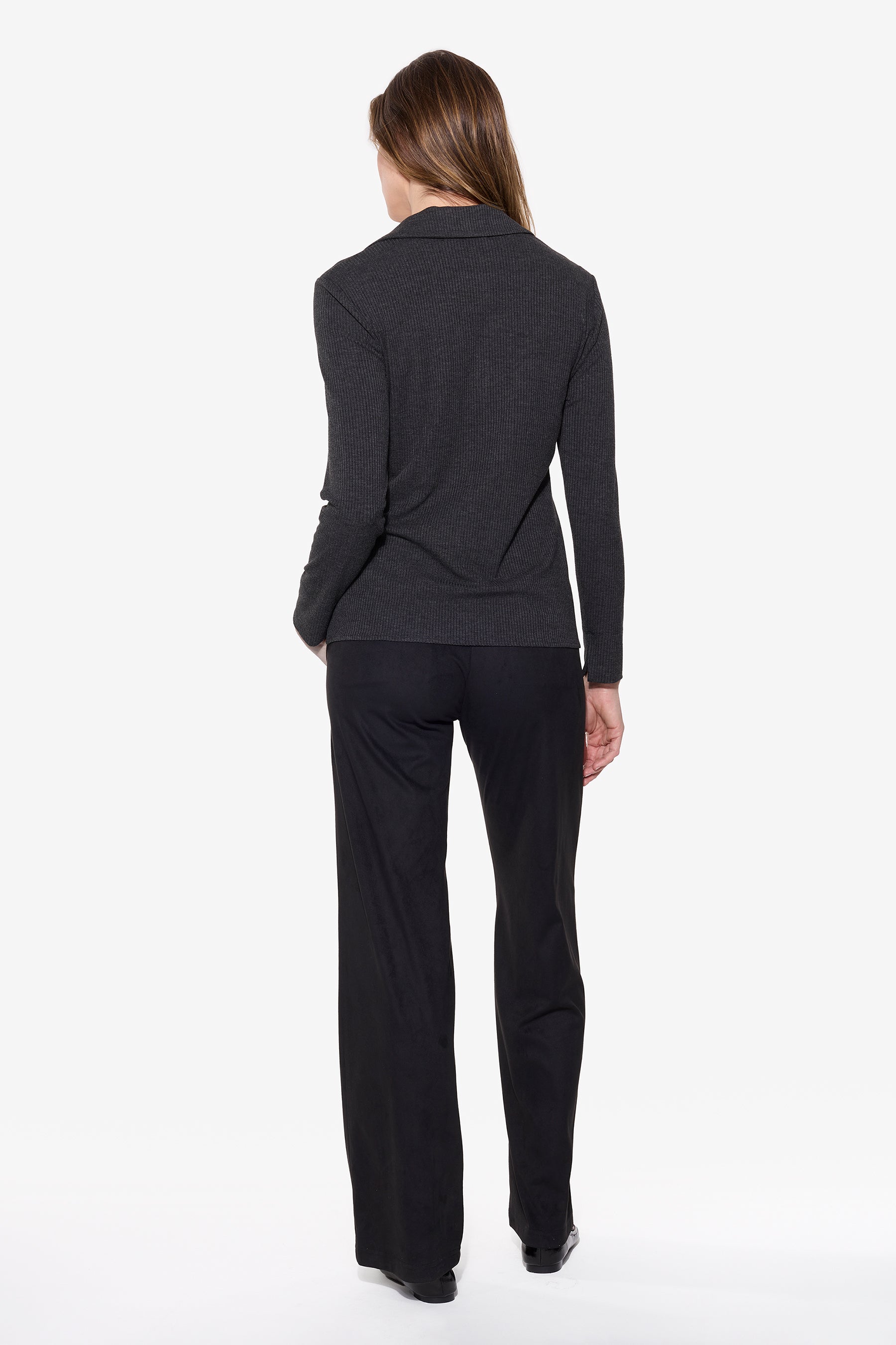 Person wearing a black outfit on a white background