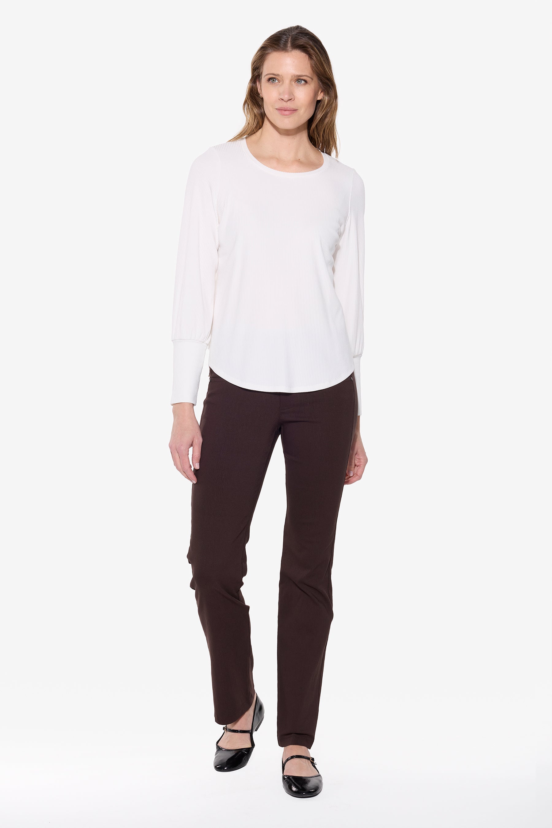Woman wearing a white blouse and black pants on a white background