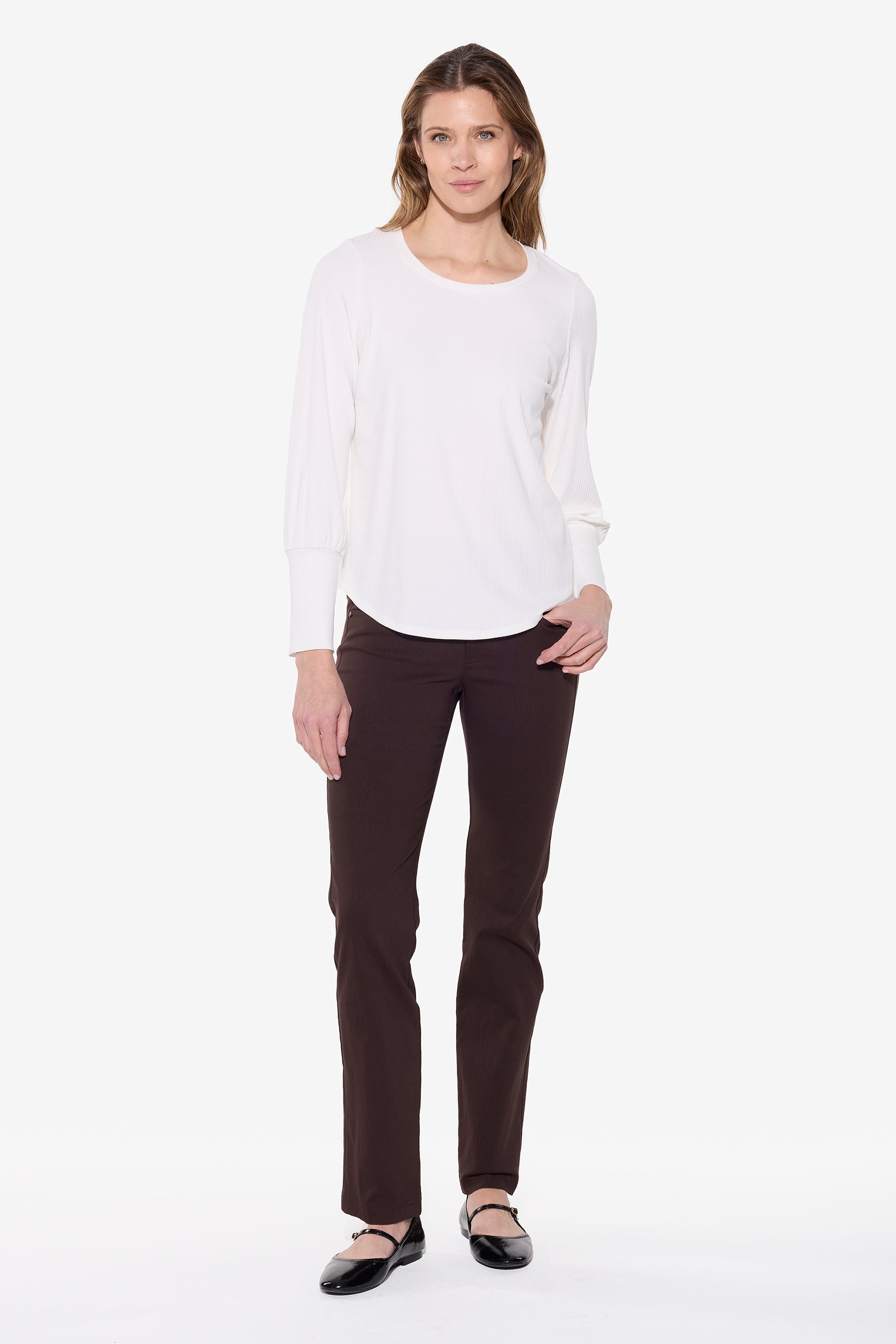 Woman wearing a white shirt and dark pants on a white background