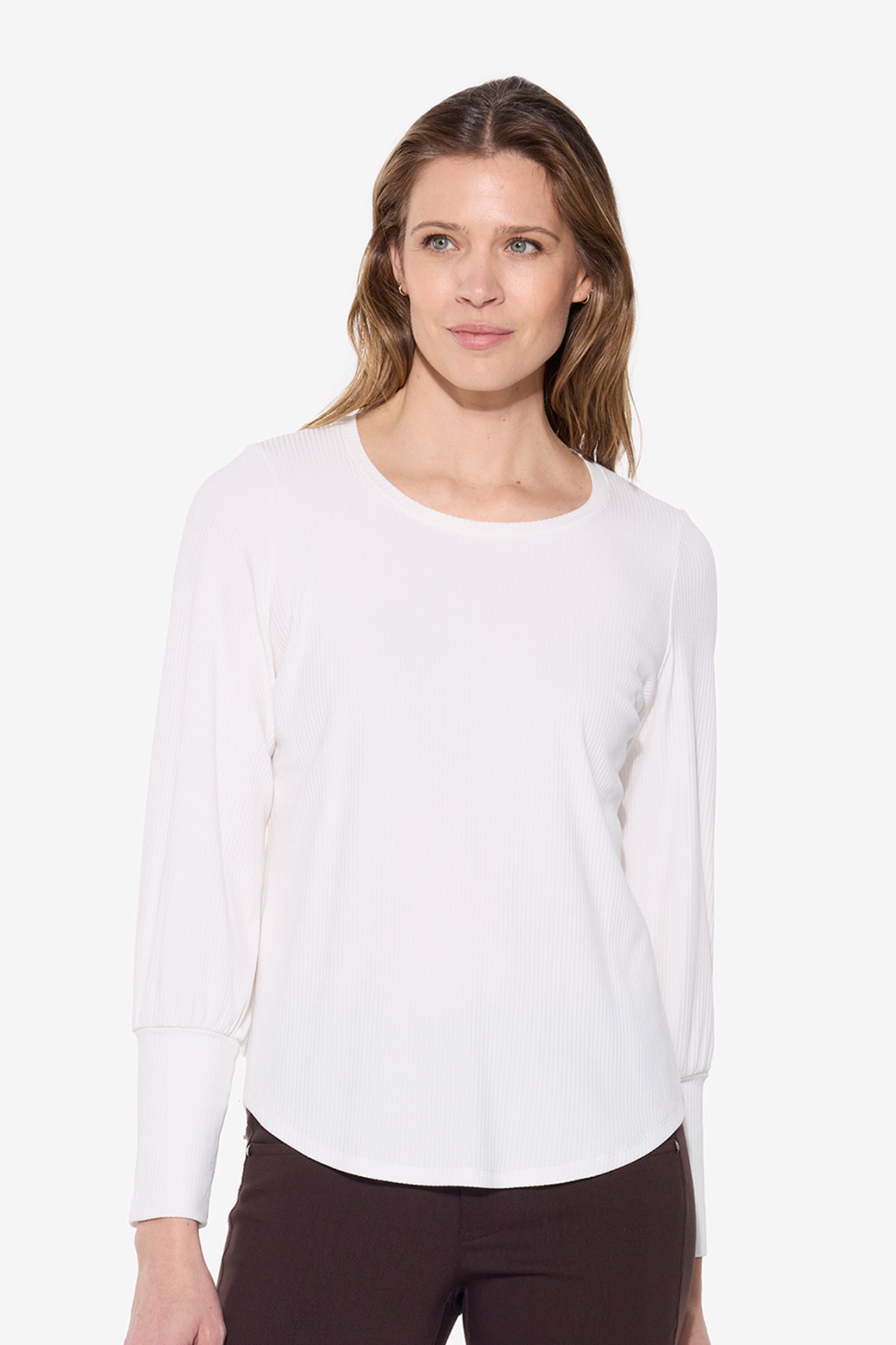 Woman wearing a white long-sleeve top on a white background