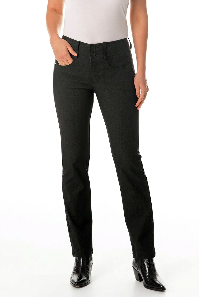 A model wearing black slim-fit jeans with a white top and black pointed-toe ankle boots, shown from the waist down on a white studio background.