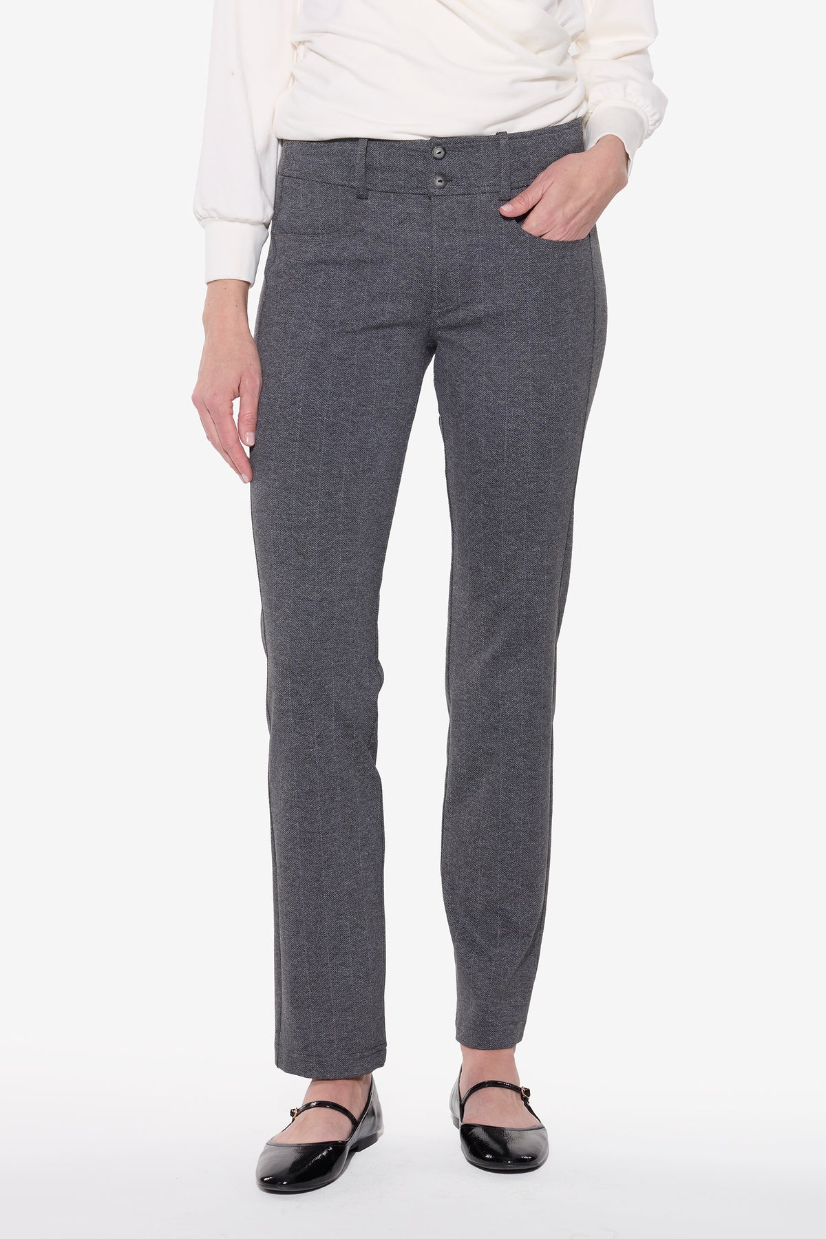 Person wearing gray pants and a white top on a white background