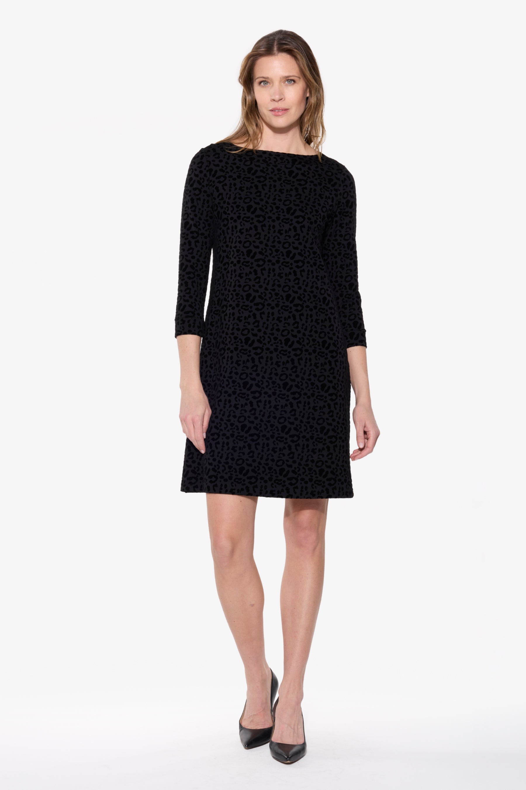 Woman wearing a black dress with a white background