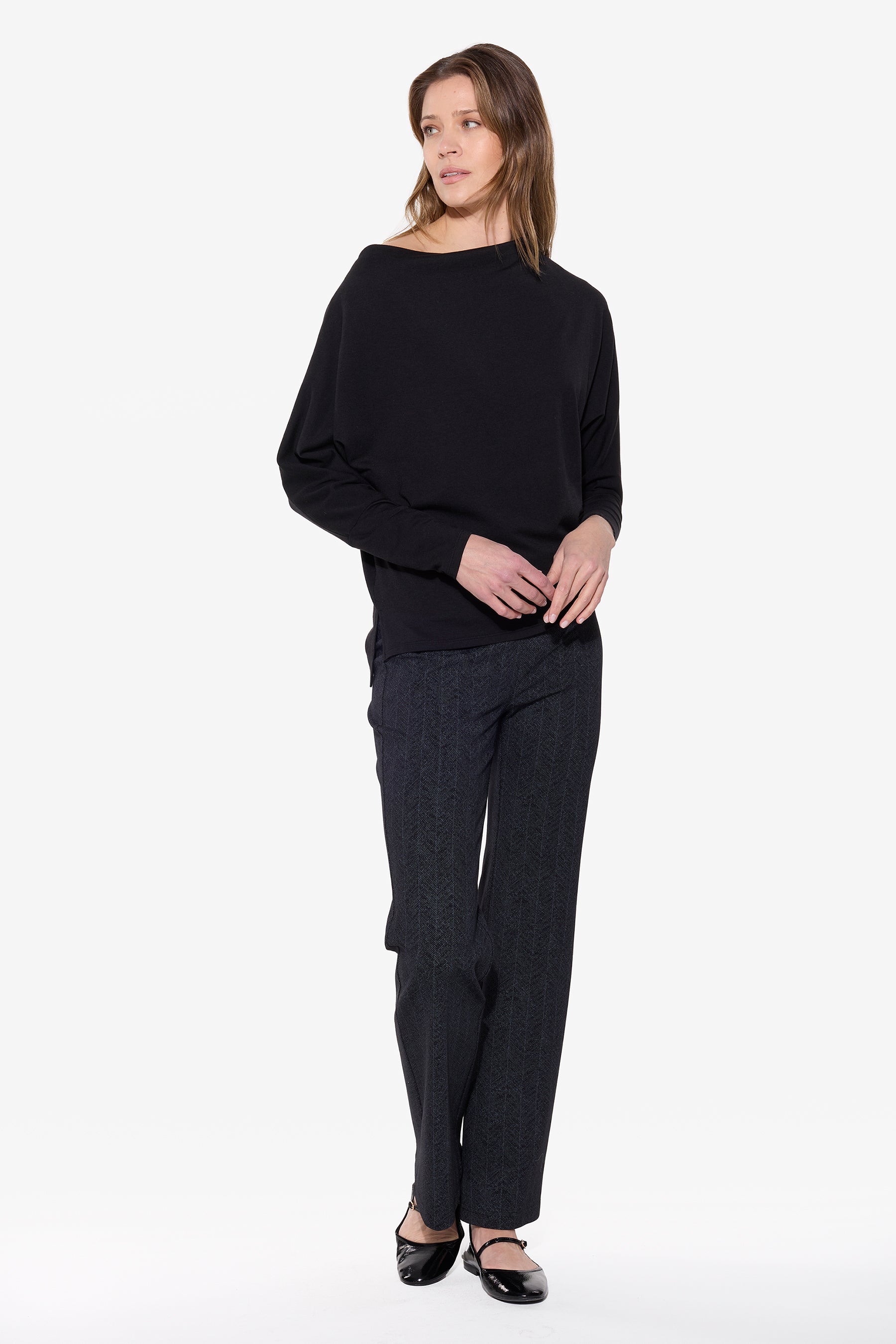 Woman wearing a black outfit on a white background