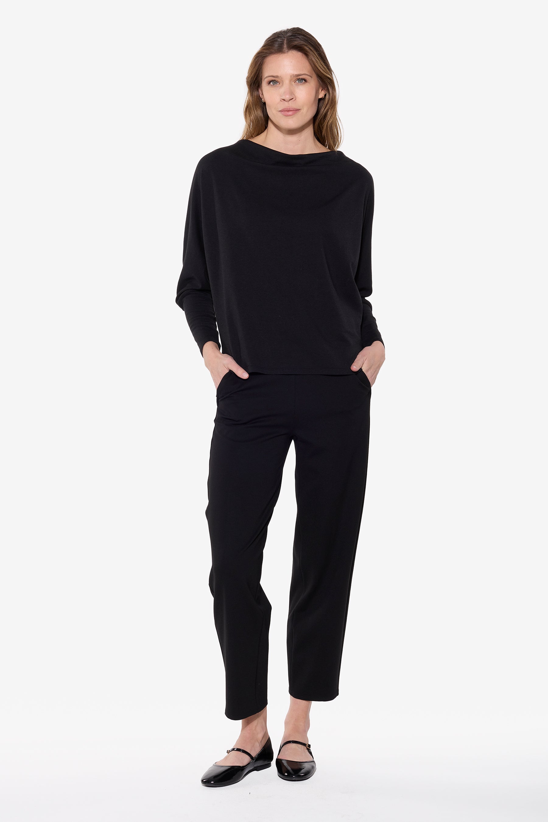 Woman wearing a black outfit on a white background