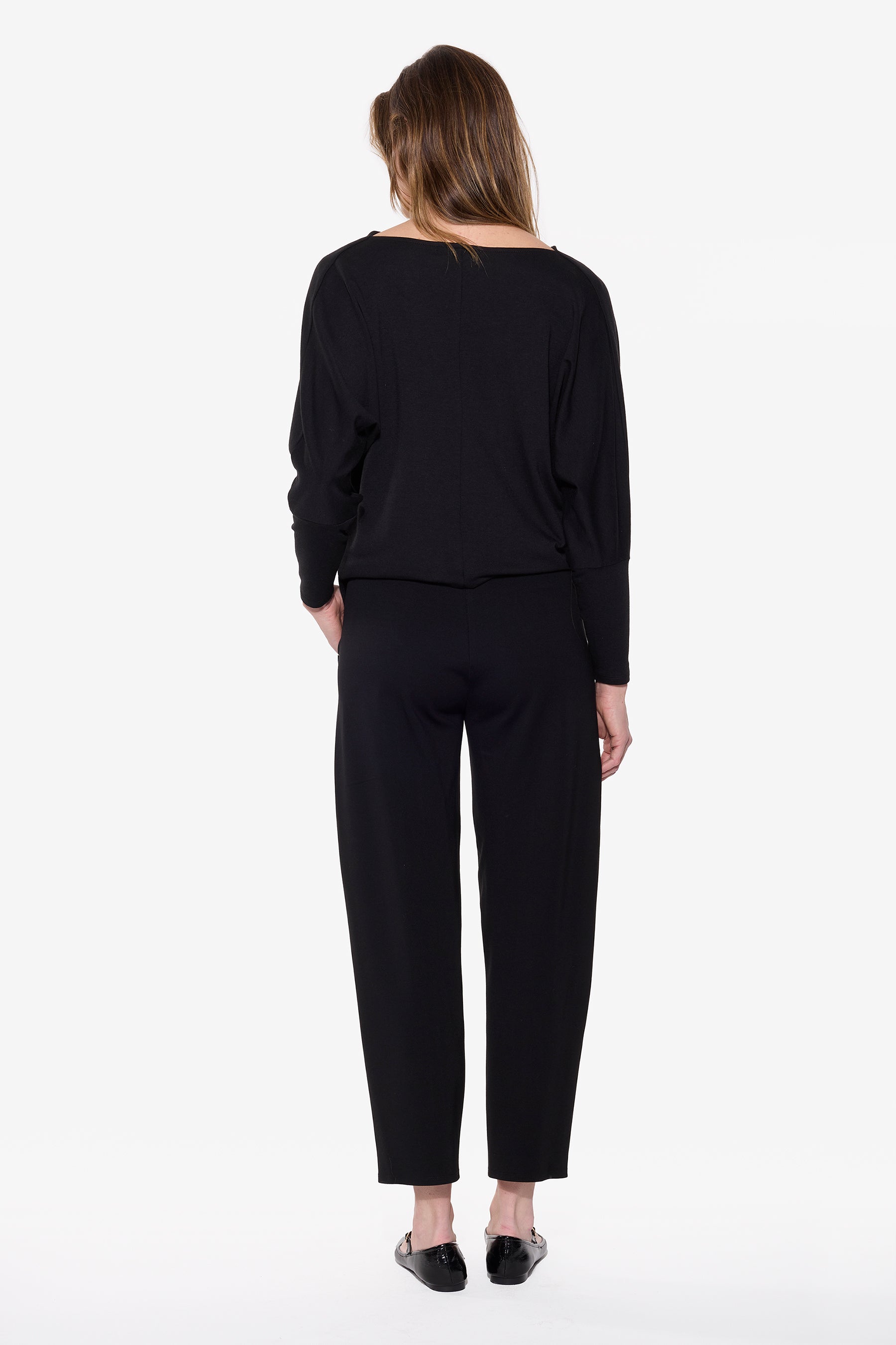 Woman wearing a black outfit on a white background