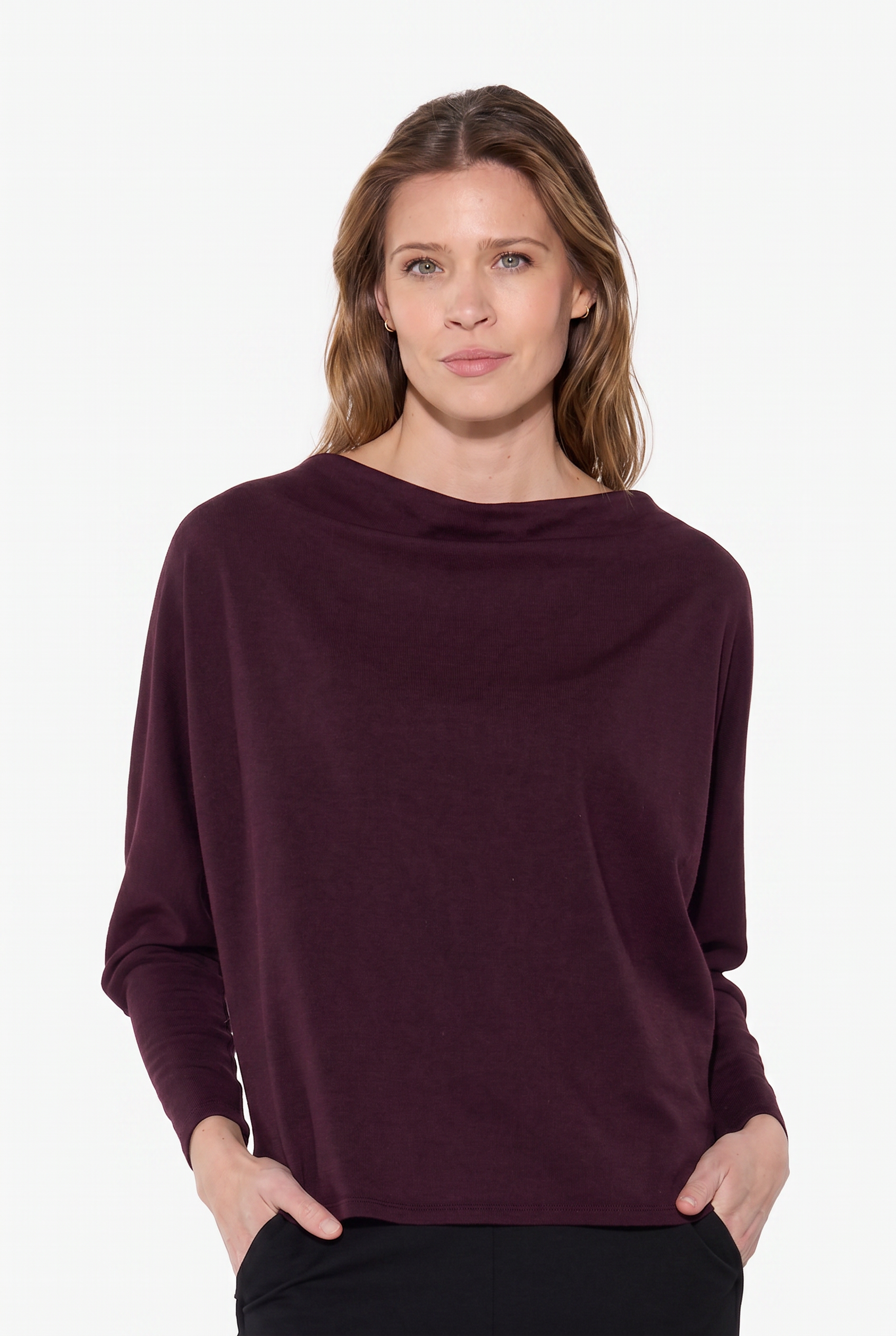 Woman wearing a dark purple sweater on a white background