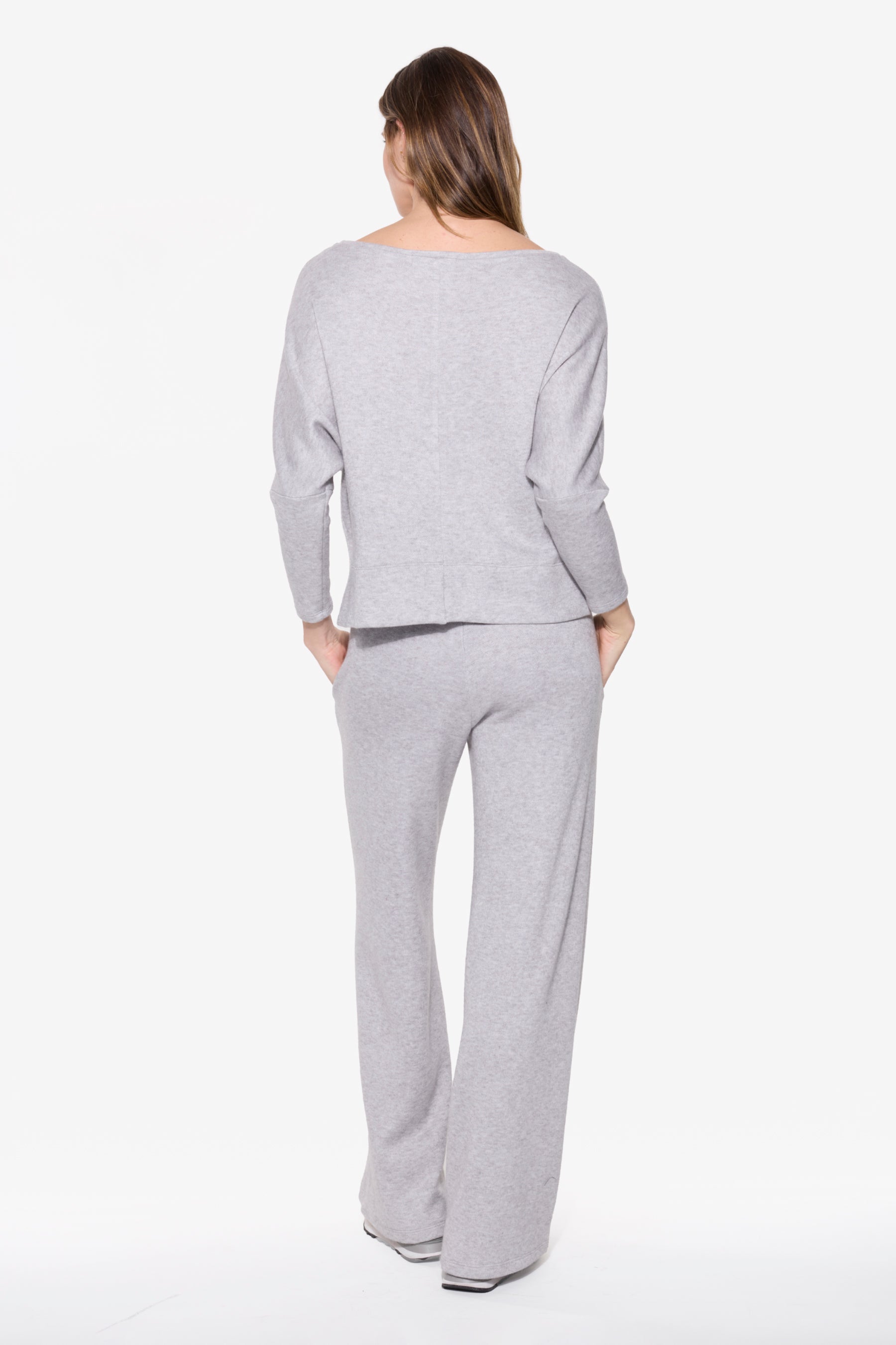 Woman wearing a gray outfit on a white background
