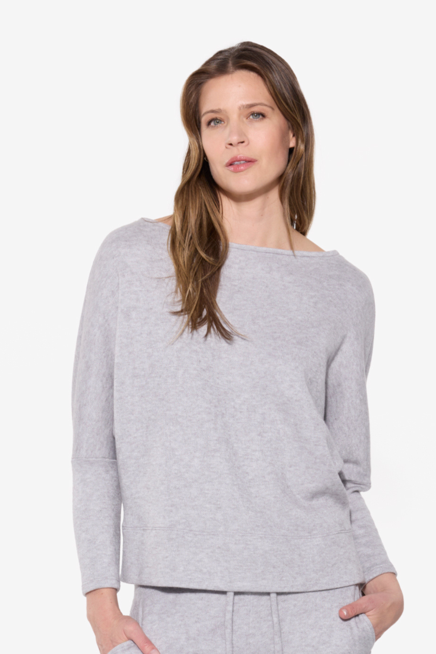 Woman wearing a gray sweater on a white background