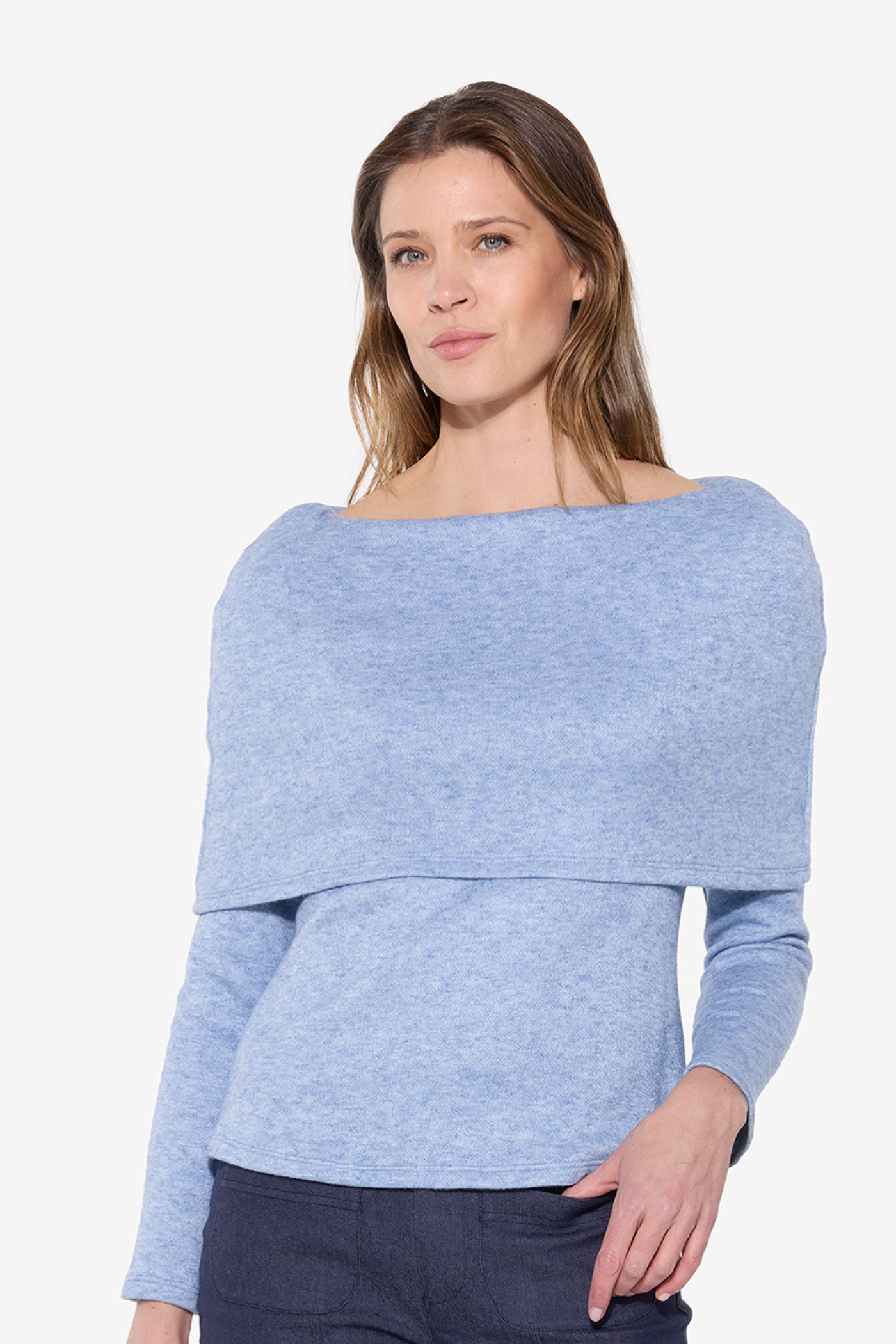 Woman wearing a light blue sweater on a white background