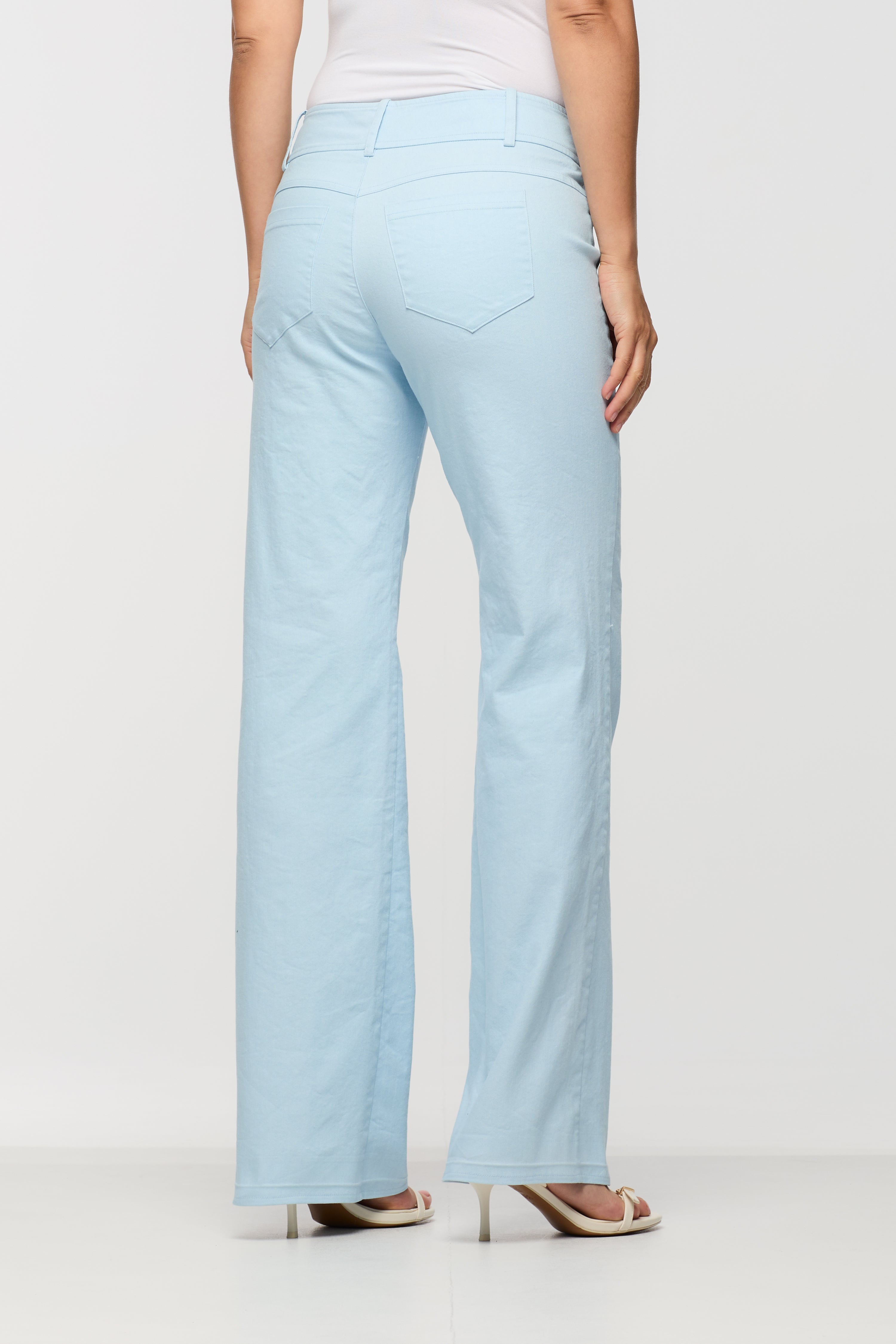 Light blue pants worn by a person on a white background