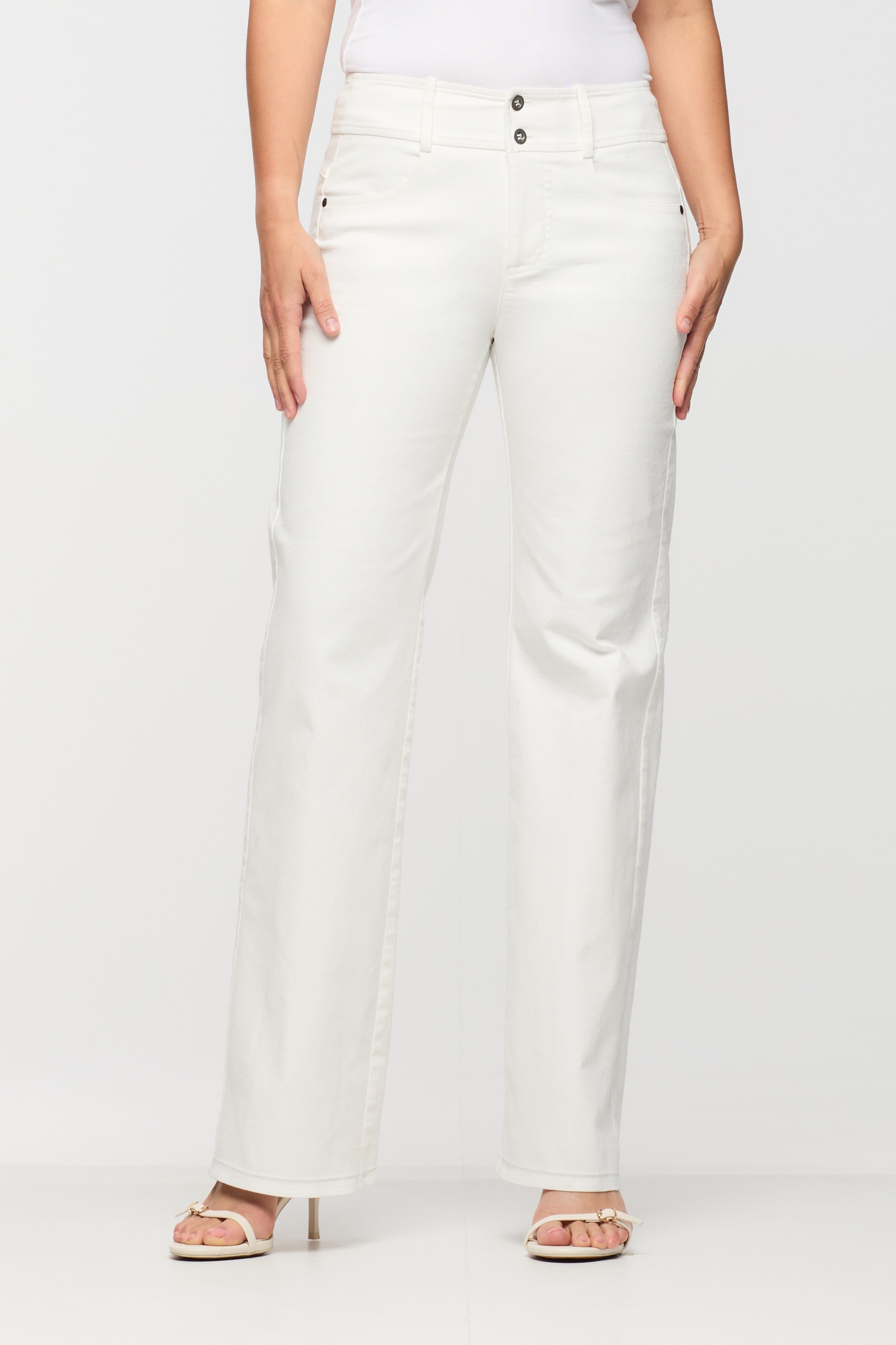 White jeans worn by a person on a white background