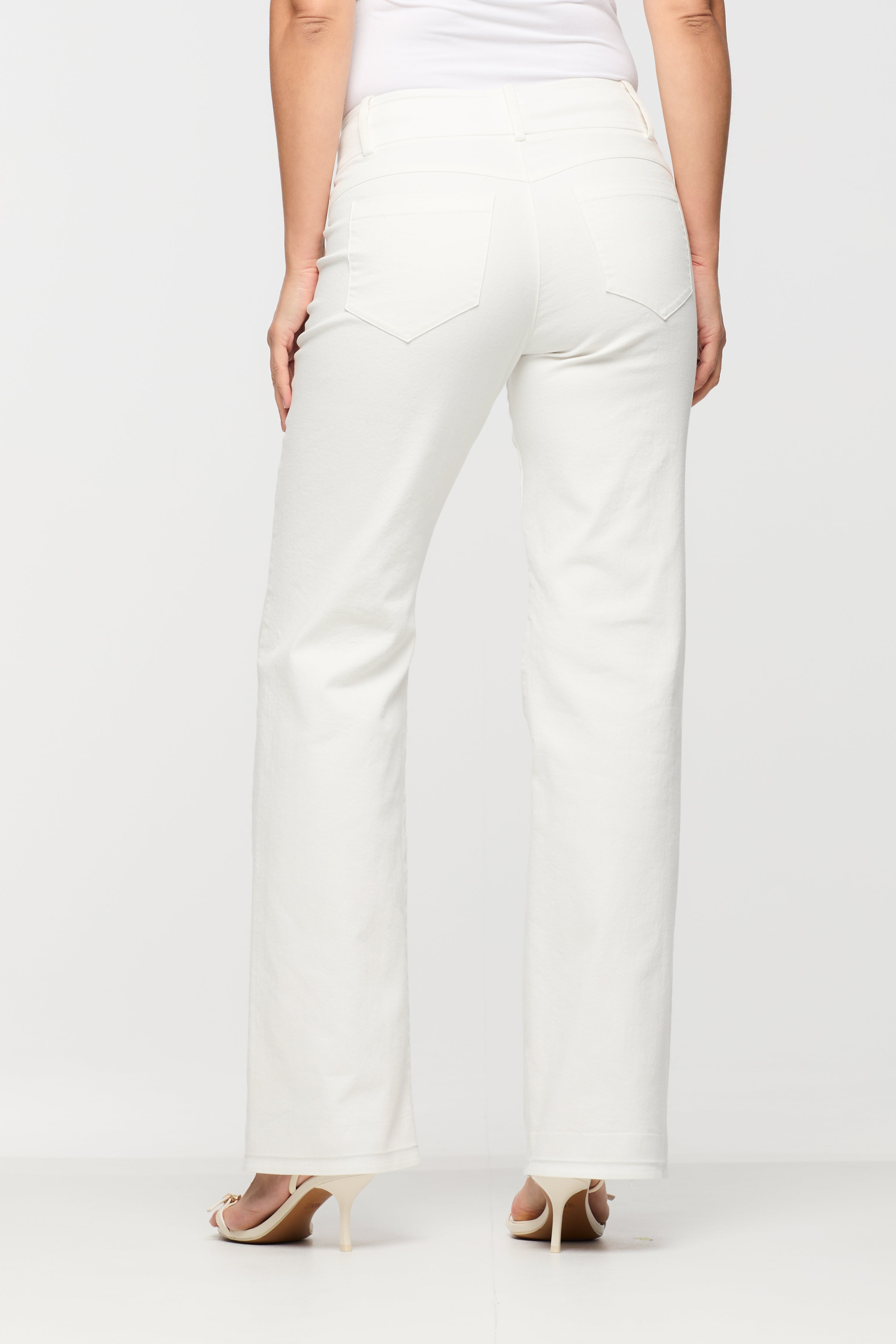 White pants worn by a person on a white background