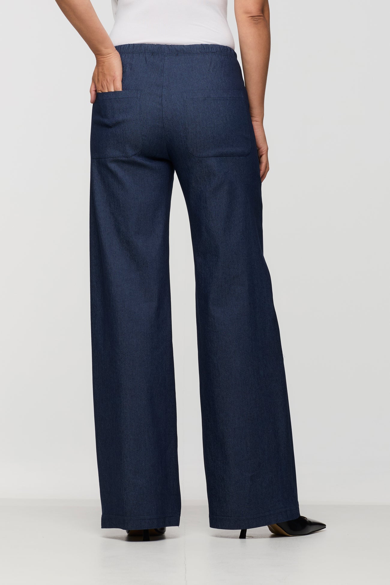 Navy blue wide-leg pants worn by a person on a white background