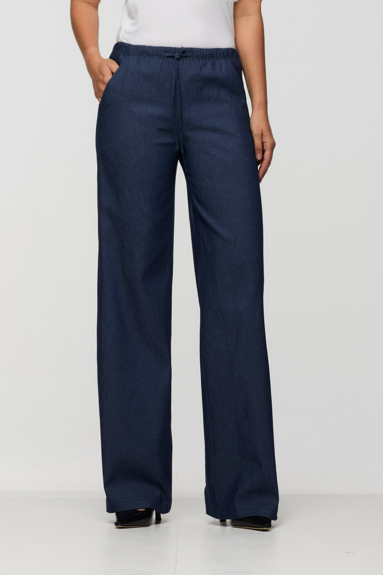 Navy blue wide-leg pants worn by a person on a white background