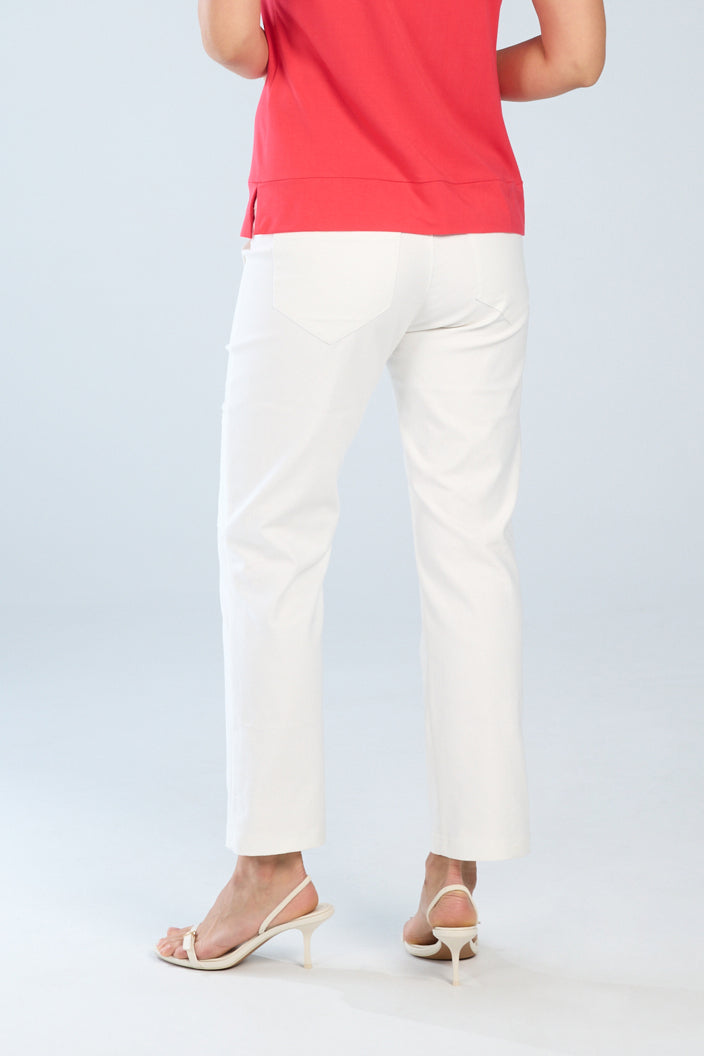 Woman wearing white stretch denim cropped cargo pants shown from the back, featuring back patch pockets and a clean straight leg fit.