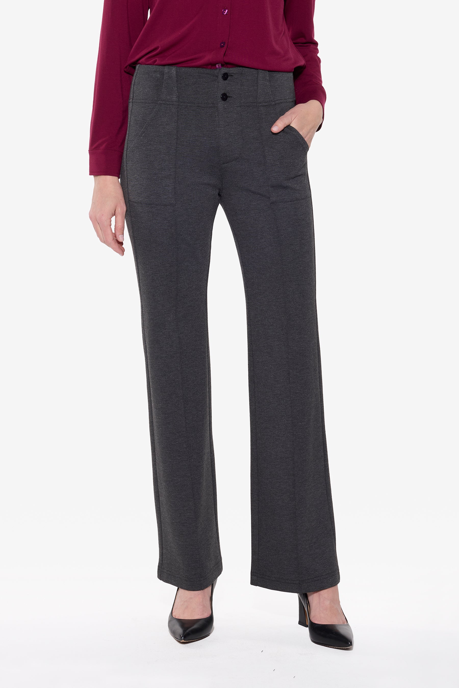 Person wearing charcoal pants and a red top on a white background
