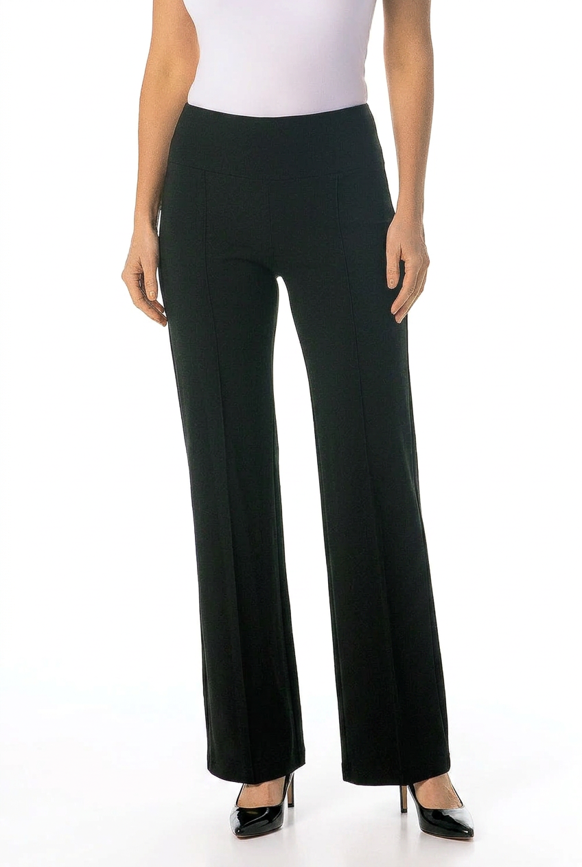 A model wearing black wide-leg trousers with a high waist, paired with a white top and black pointed-toe heels, shown against a plain white background.