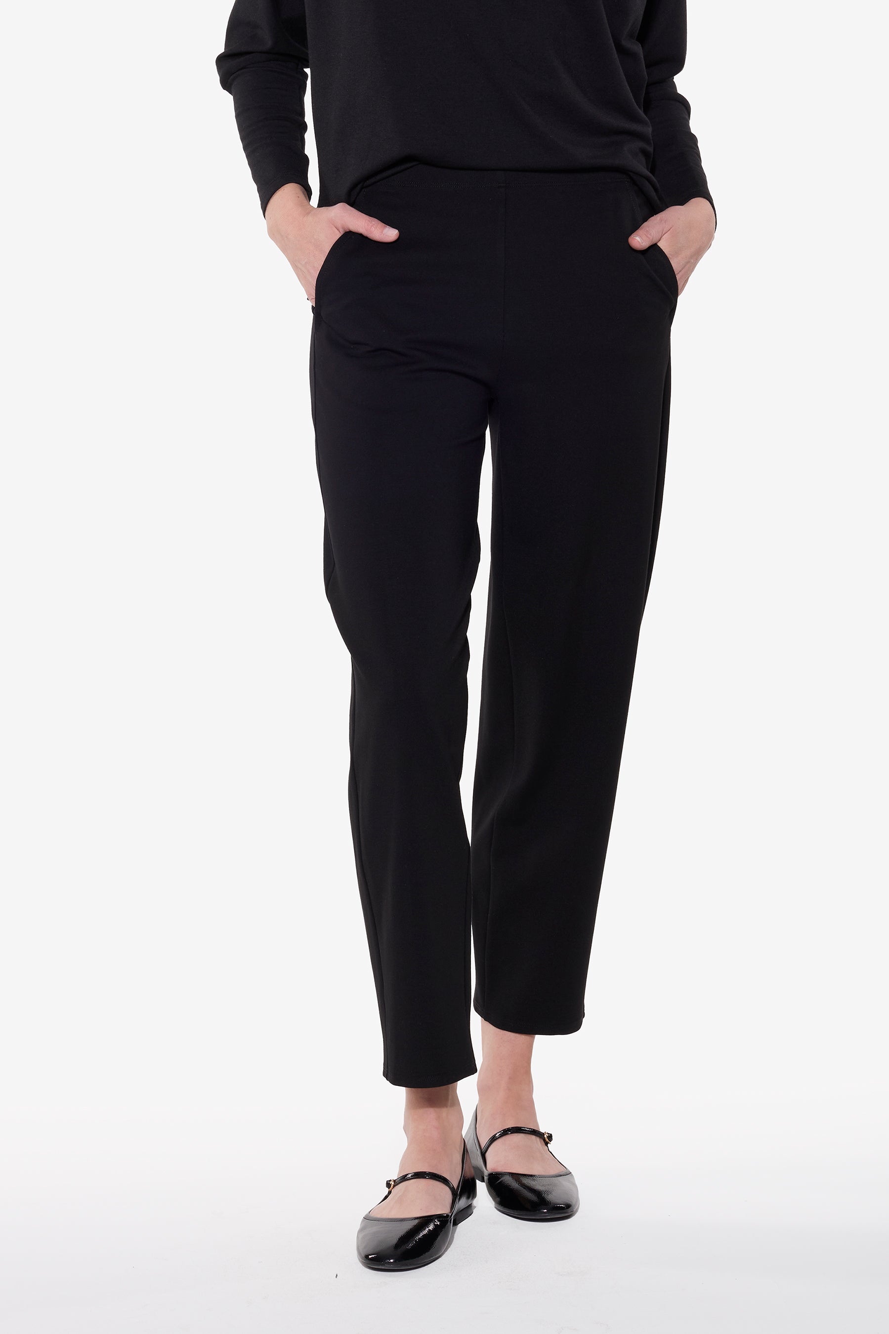 Person wearing black pants on a white background