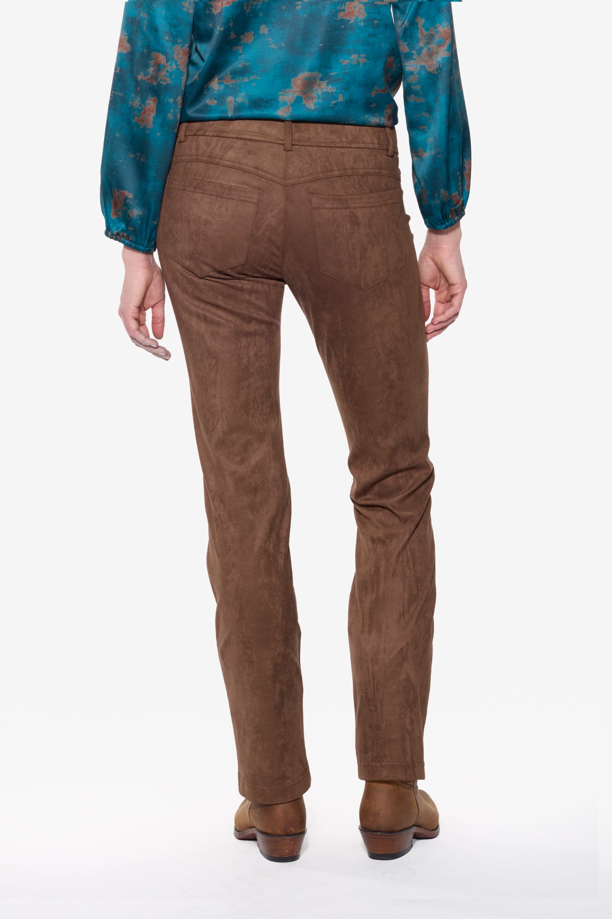Brown stretch suede pants worn by a person on a white background