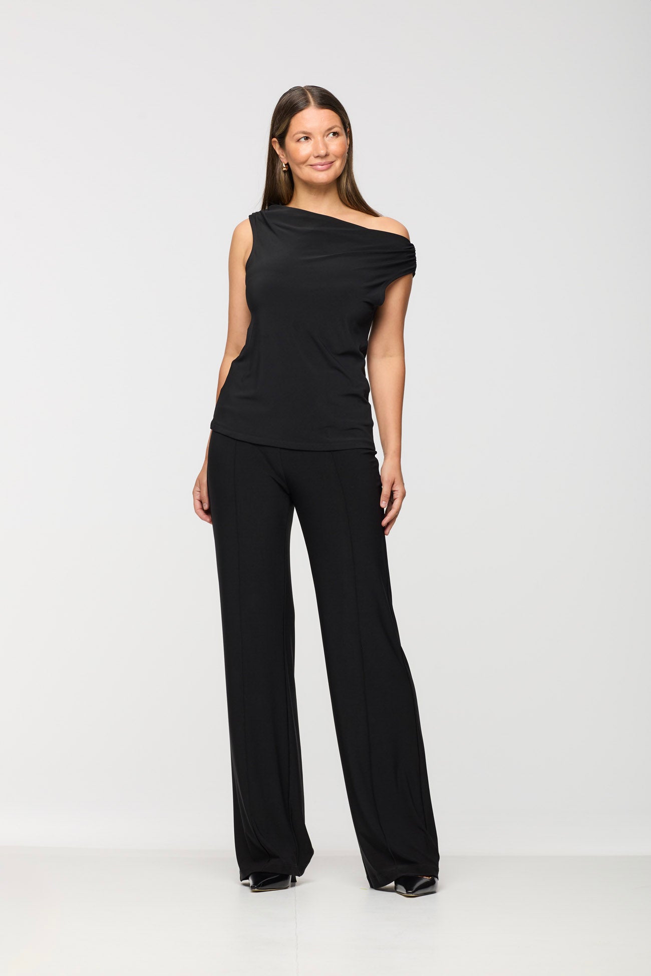 Woman wearing a black outfit on a white background