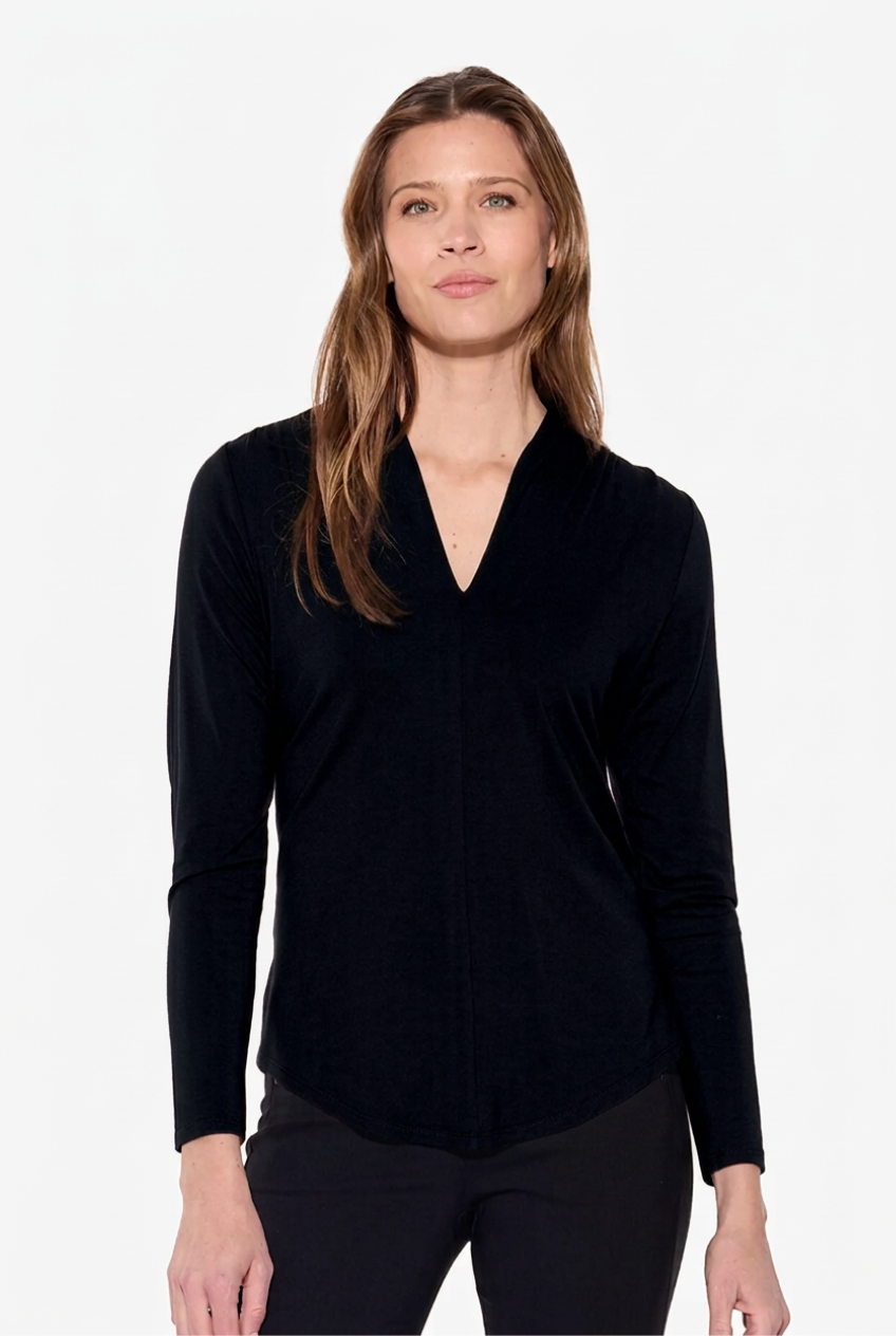A woman modeling a black long-sleeve wrap-style top against a plain white studio background.